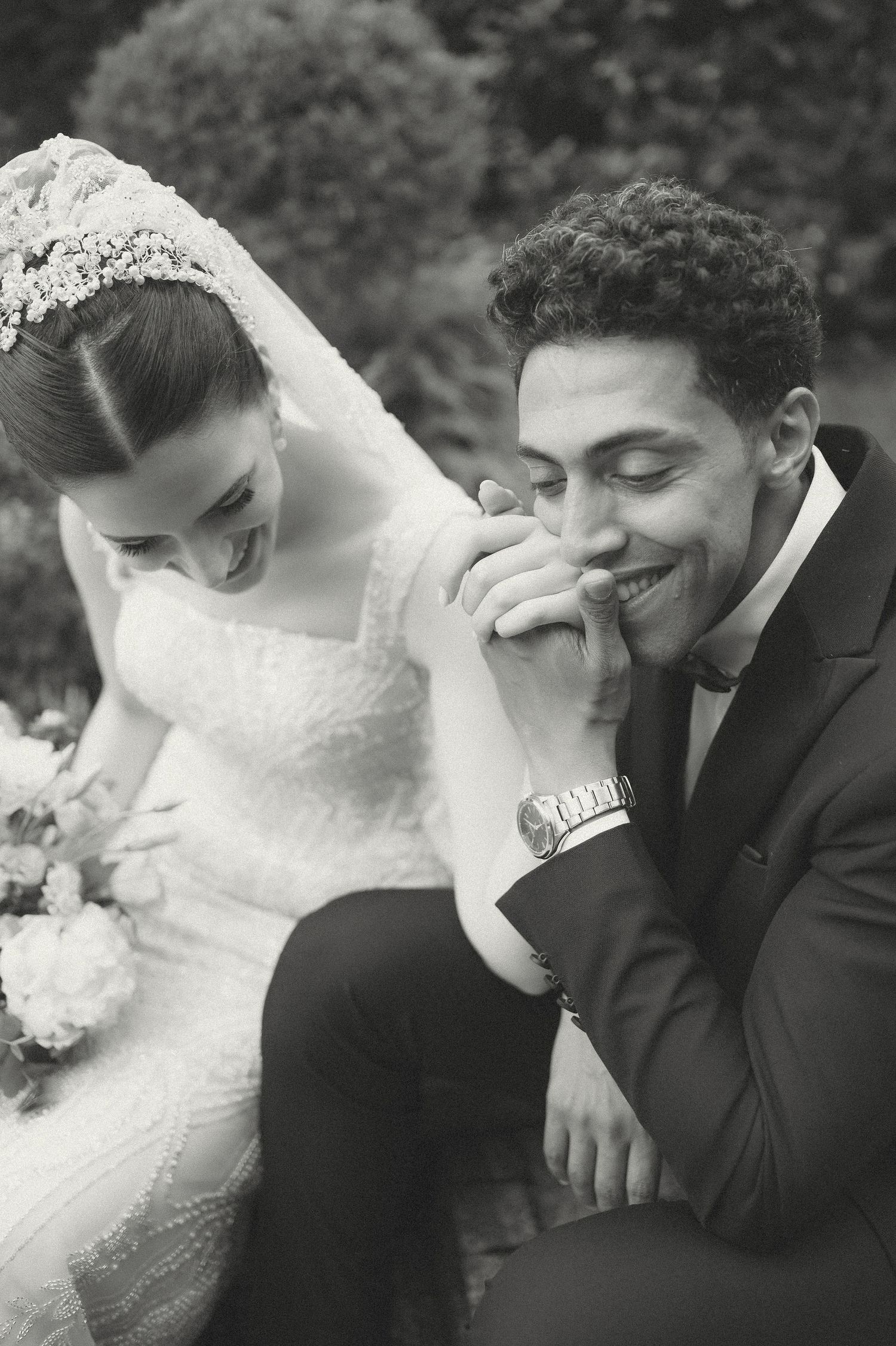 Intimate black and white wedding photos capturing candid moments between newlyweds.