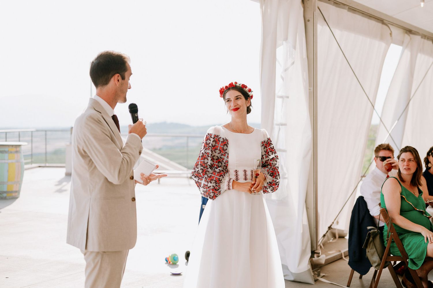 Elegant white tent wedding ceremony with guests gathered for special moments.