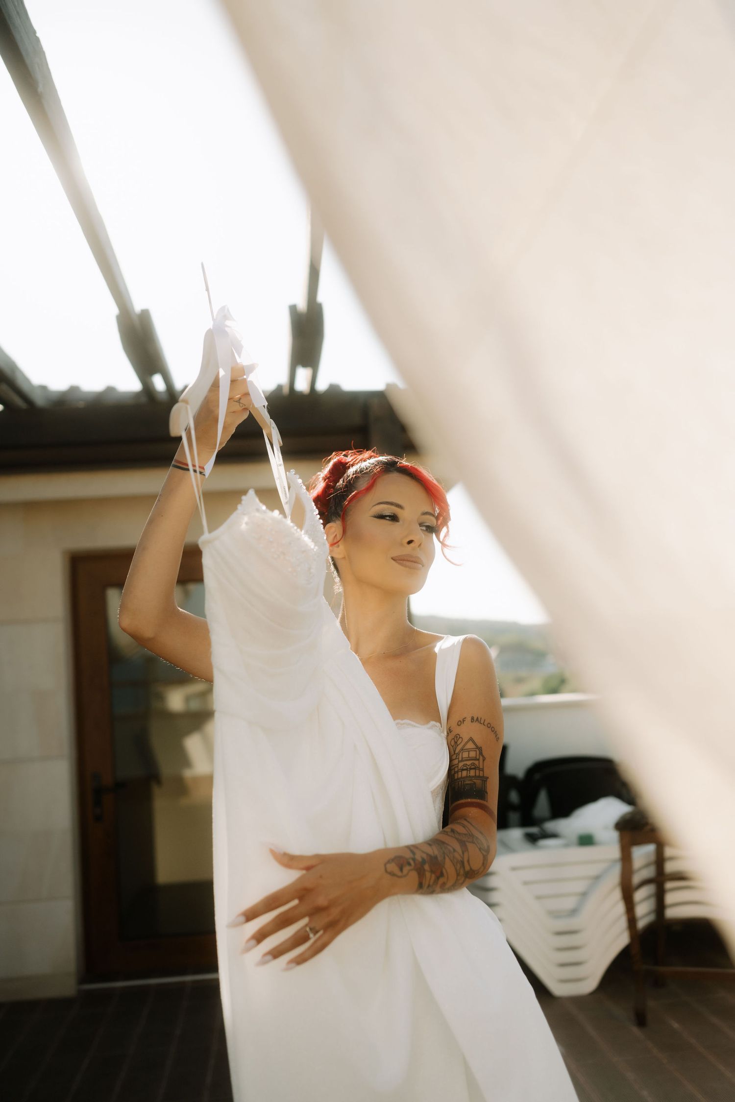 A sequence of dance-like movements in a sunlit room showing graceful poses in a white flowing dress.