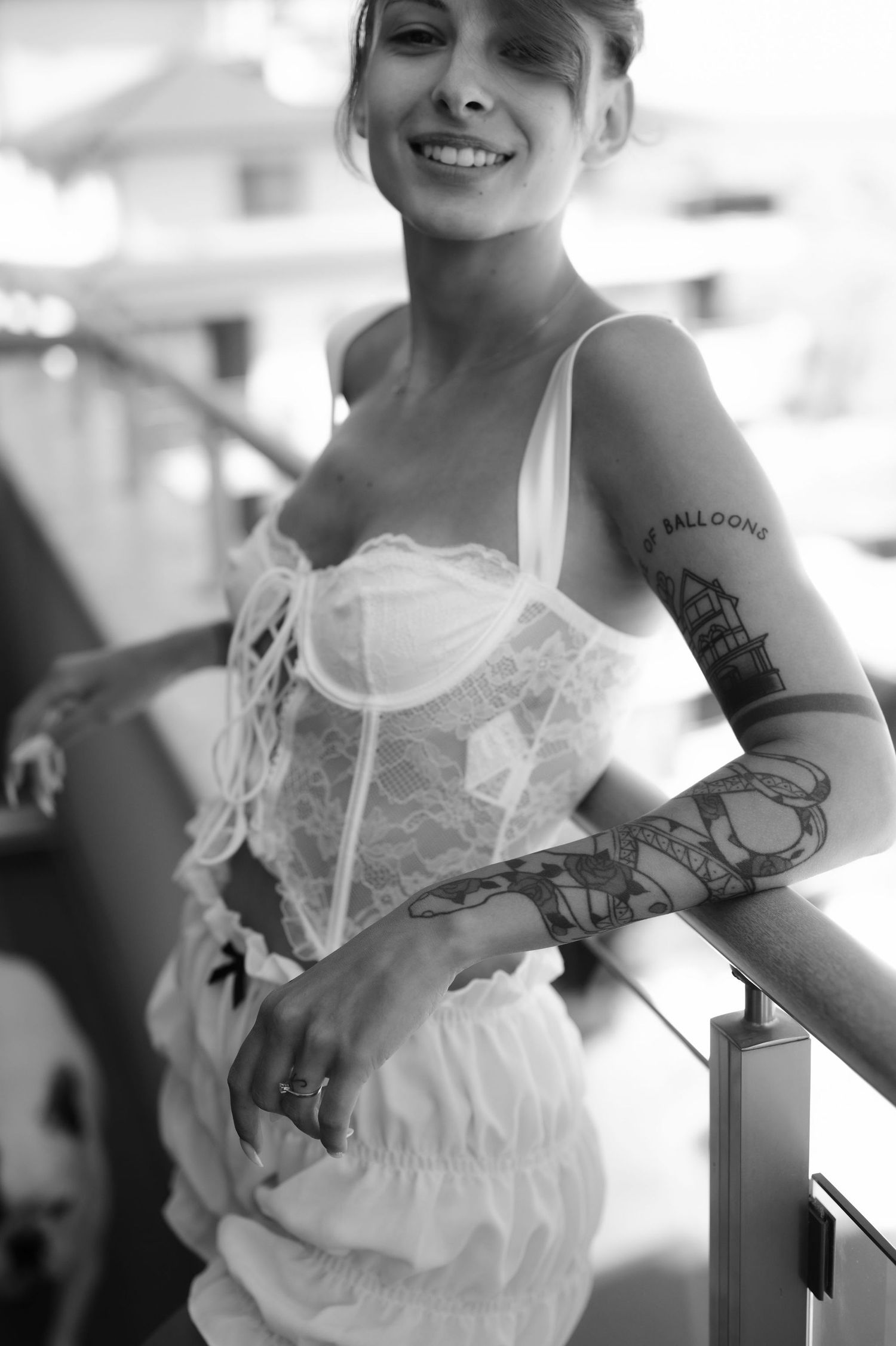 A series of black and white photos showing someone in a white dress holding a balloon against a light background.