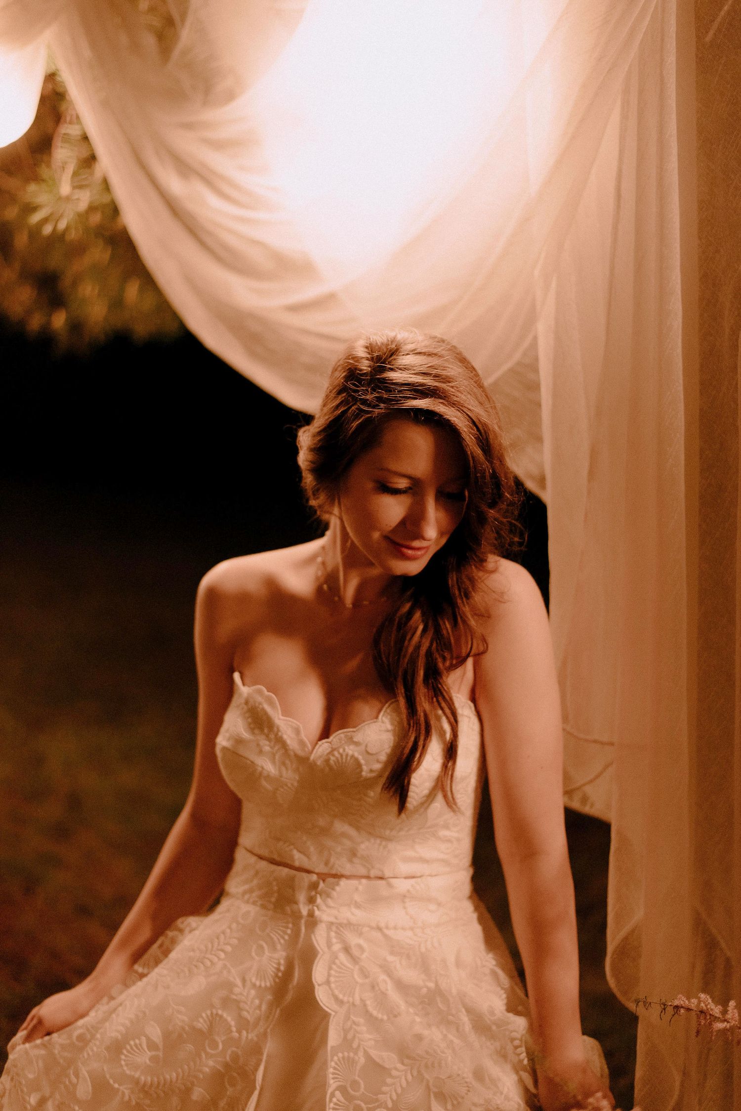 Flowing white wedding dress fabric captured in an artistic motion blur.