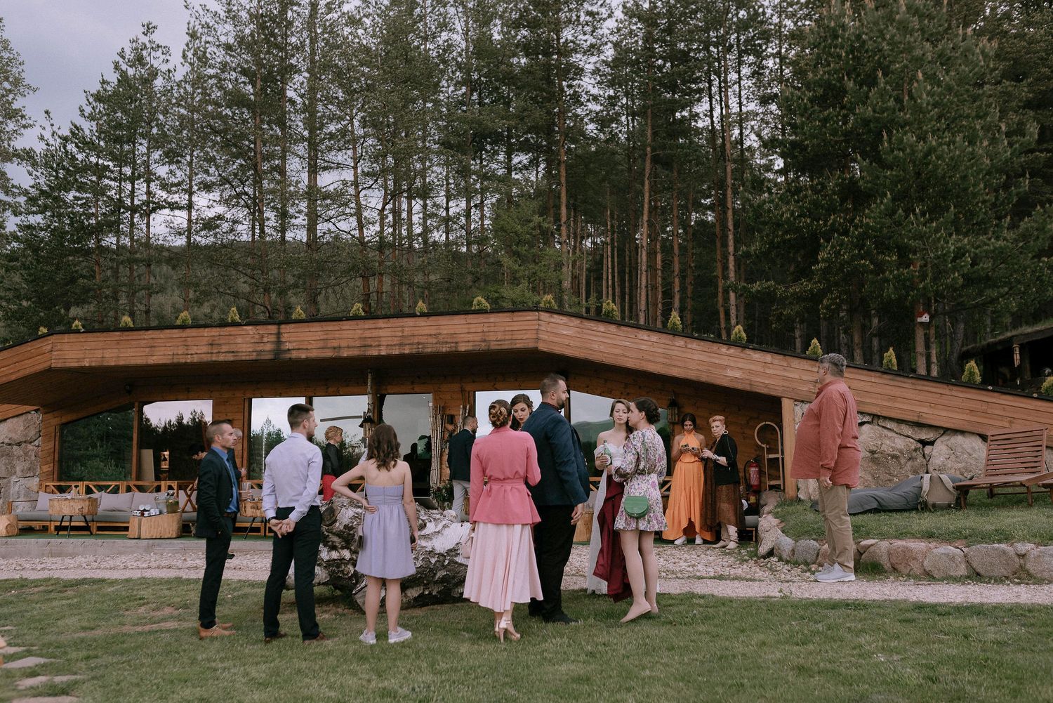 Panoramic view of wedding venue with wooden structure and mountain landscape.
