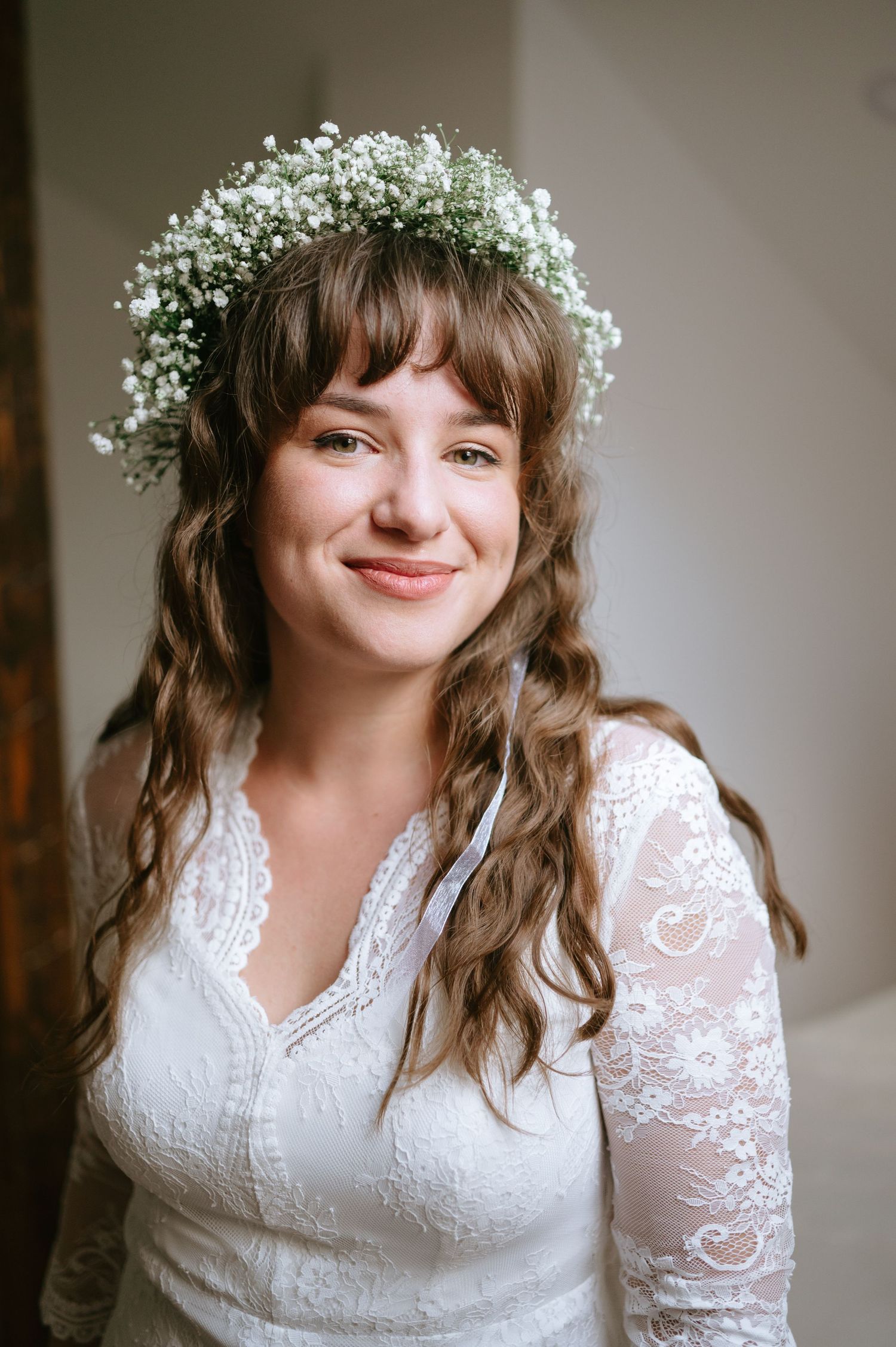 Wedding portrait featuring white lace dress and baby's breath crown.