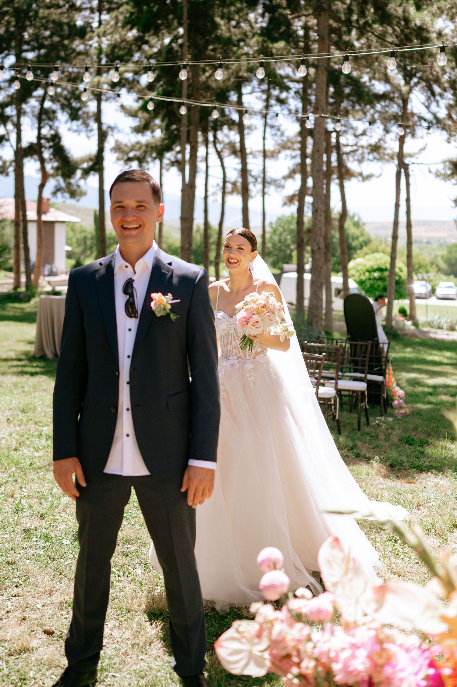 Wedding ceremony location in a pine grove with romantic lighting and floral details.