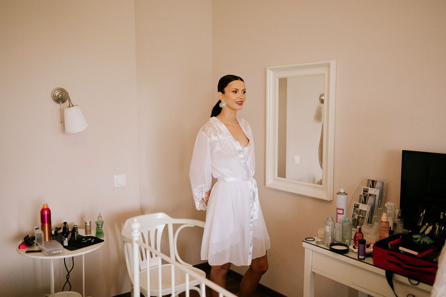 Interior view of a bright room with white furniture and decor.