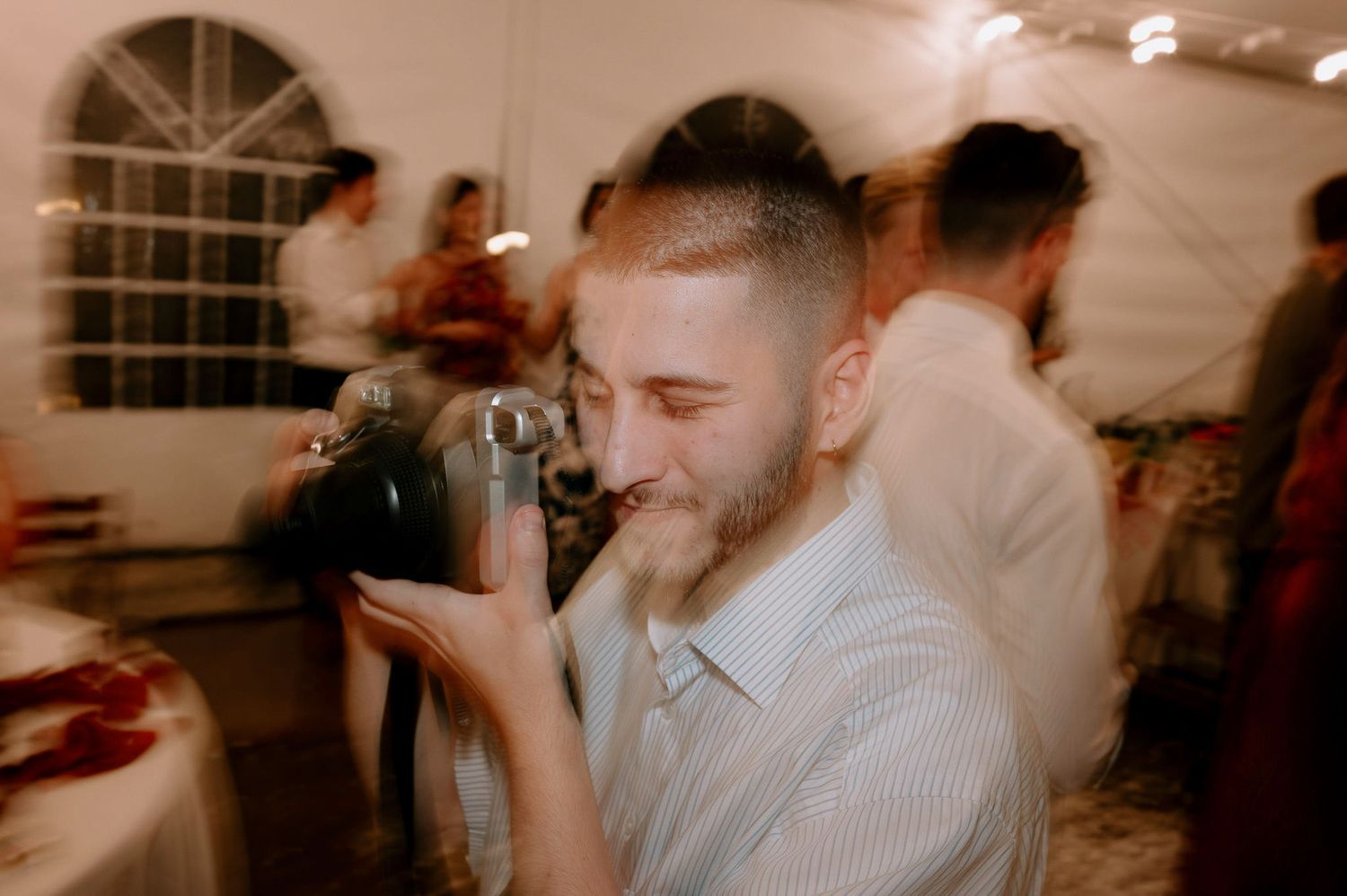 Candid moments of celebration captured during a dimly lit wedding reception.
