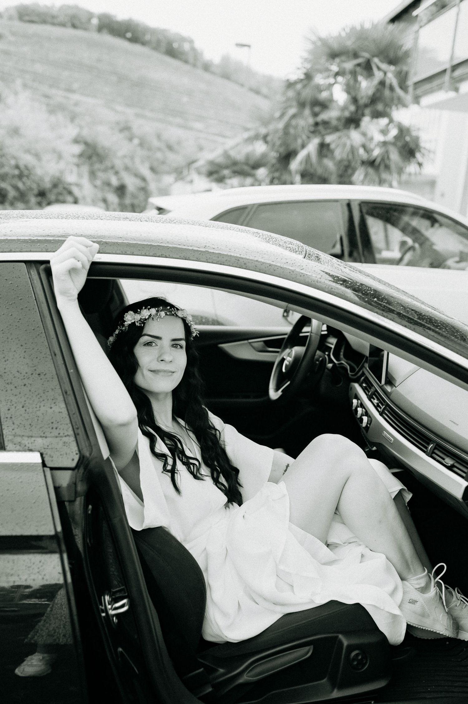 Black and white photo series of a bride sitting elegantly in a luxury car.