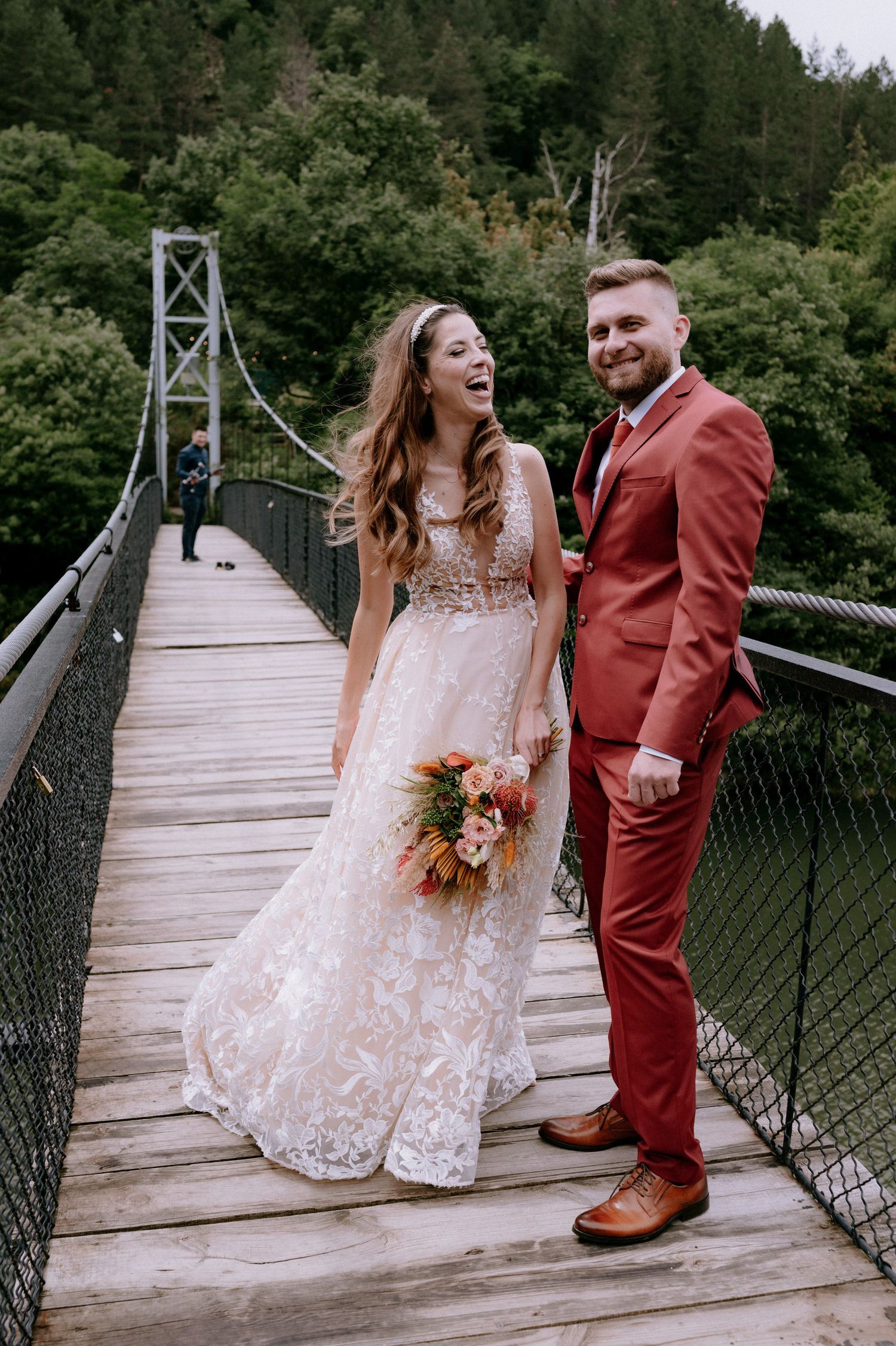 A romantic wedding photoshoot sequence on a wooden suspension bridge surrounded by lush forest scenery.