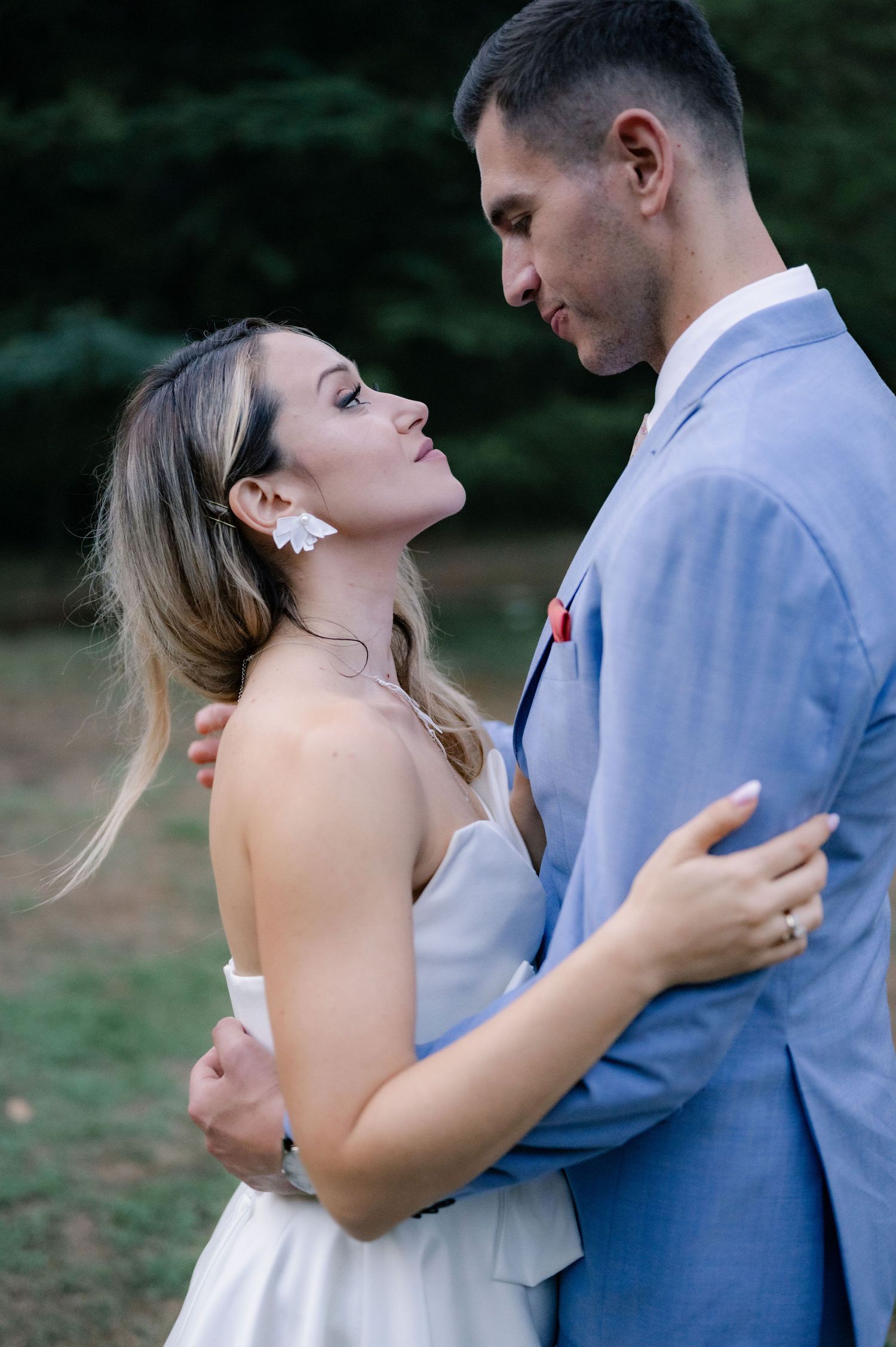 Romantic sequence of a couple in wedding attire embracing and sharing intimate moments outdoors.