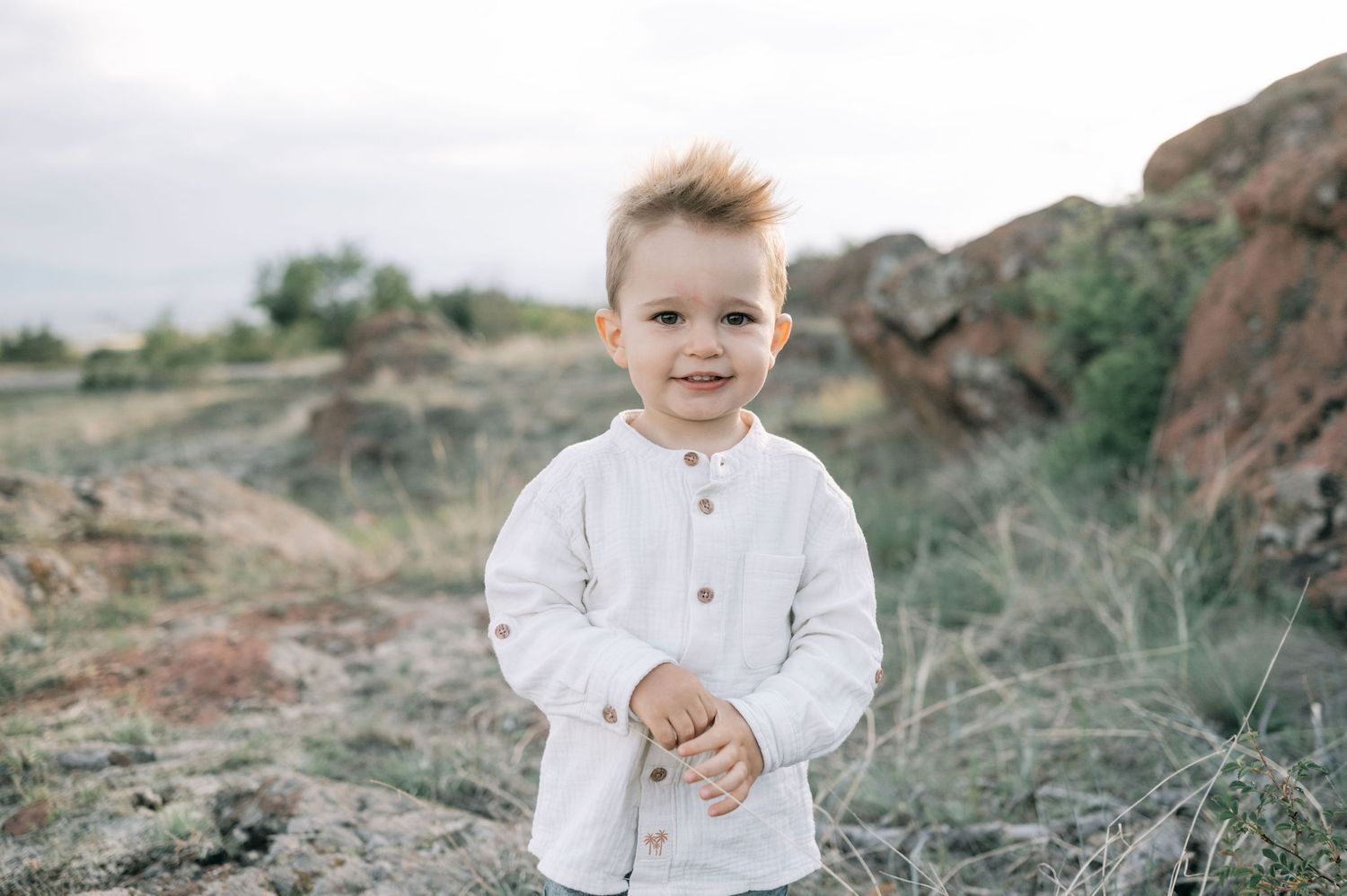 A series of outdoor portraits showing someone in a white shirt against a natural rocky landscape backdrop.