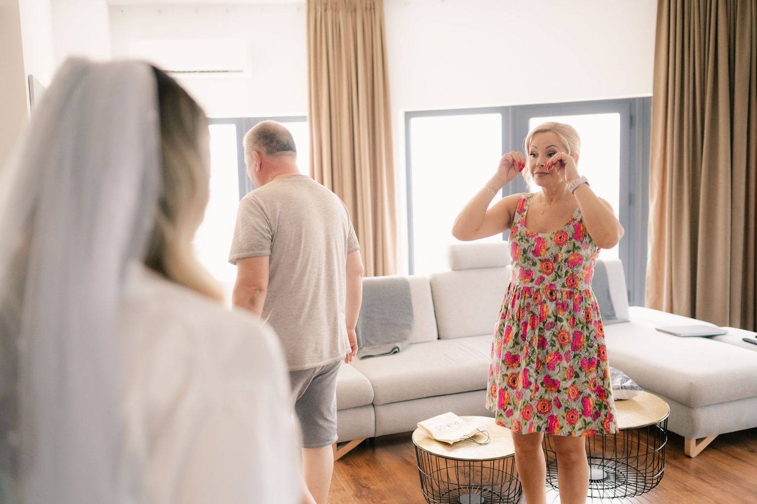 A sequence of photos showing a couple getting ready in a bright hotel room with beige curtains and white bedding.