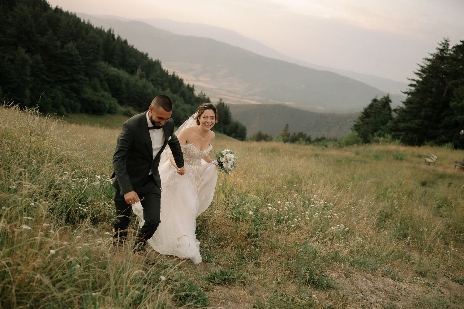 A romantic moment captured in a wildflower meadow with mountain vistas in the background.