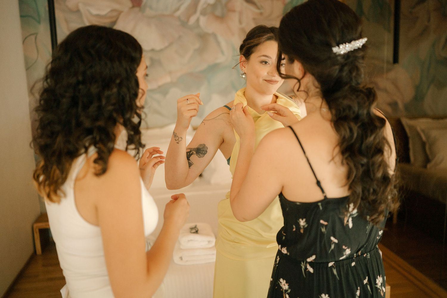 A group of people in formal attire dancing and celebrating at an indoor party or reception.