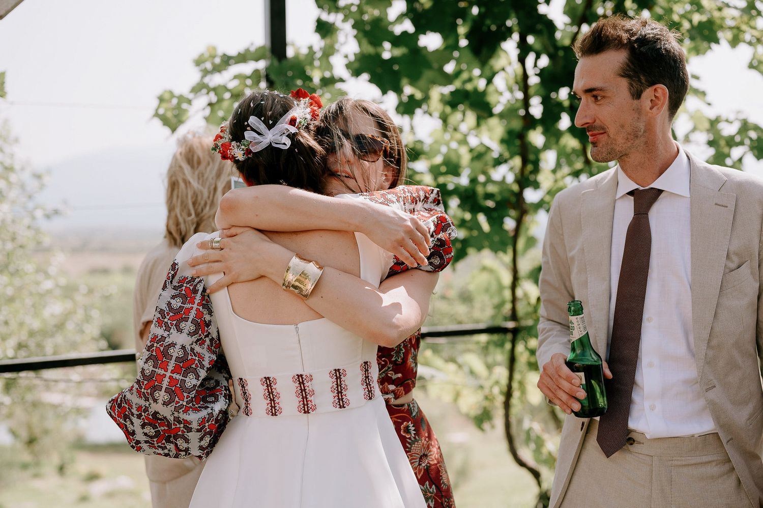 Wedding celebration moments captured outdoors with guests in formal attire.