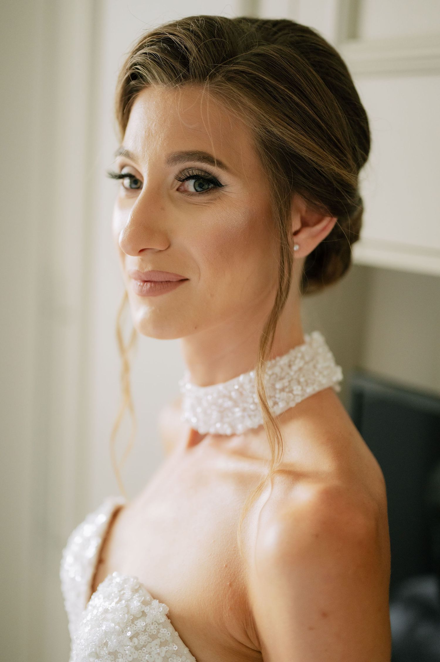 Artistic bridal portrait highlighting elegant makeup and hair styling.