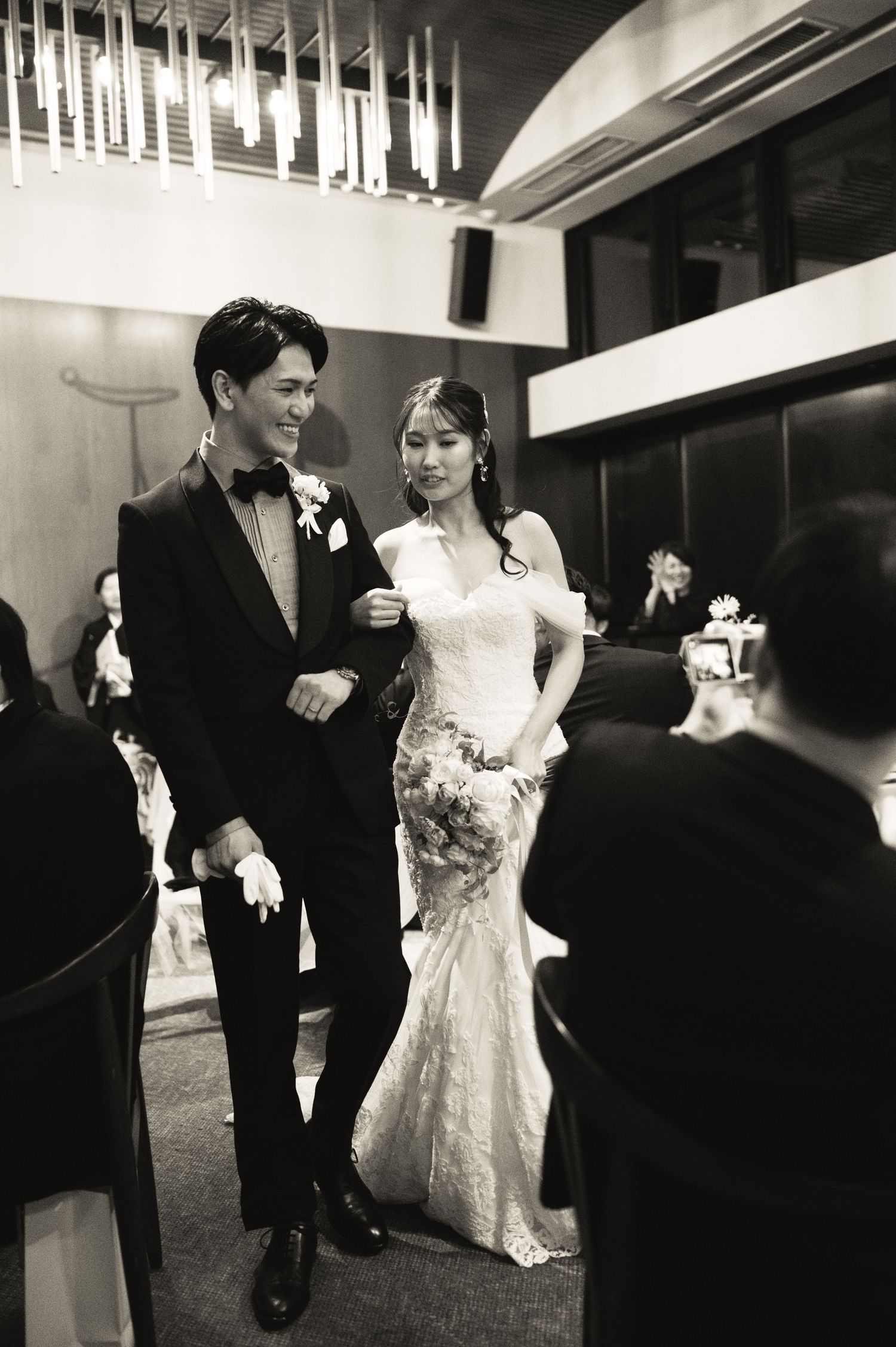 Black and white wedding photos showing couple walking together in formal attire.