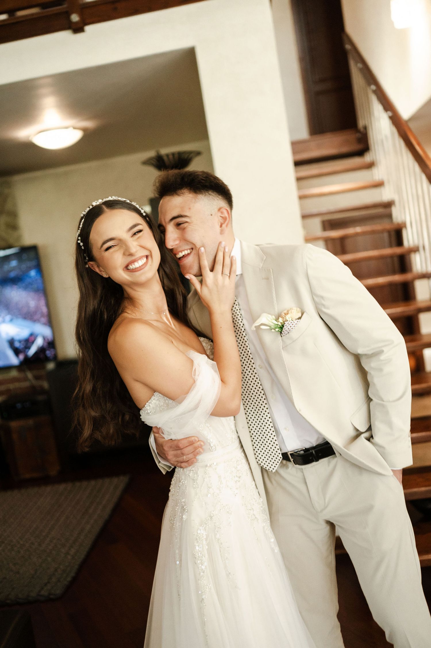 A romantic wedding photoshoot featuring a couple in white attire near a staircase.