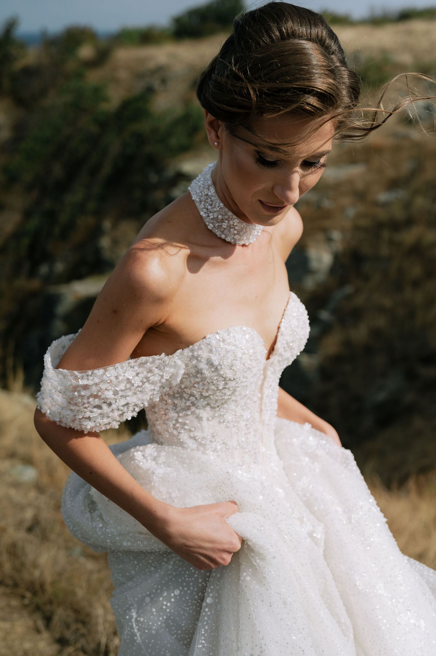 Close-up details of an ornate white wedding dress with delicate lace patterns.
