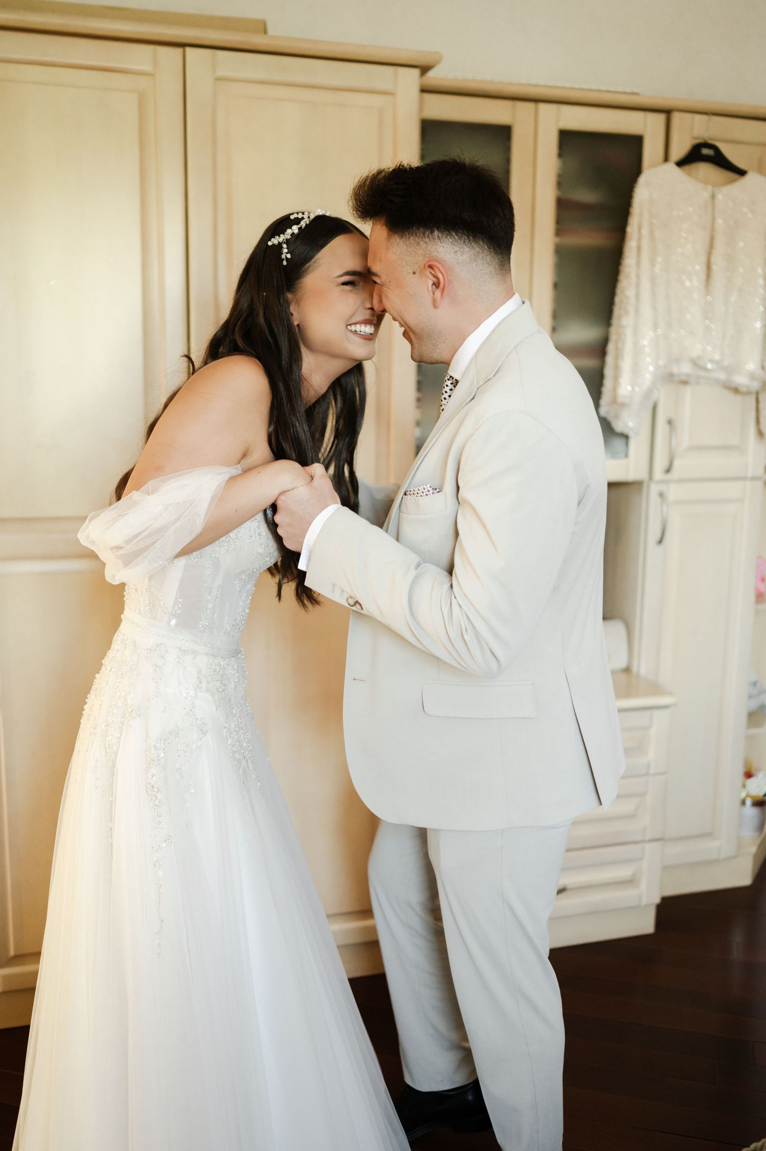 A couple laughs together during their wedding first look moment.