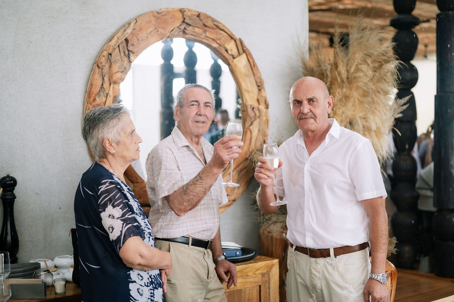Guests enjoying drinks and conversation at an indoor social gathering.