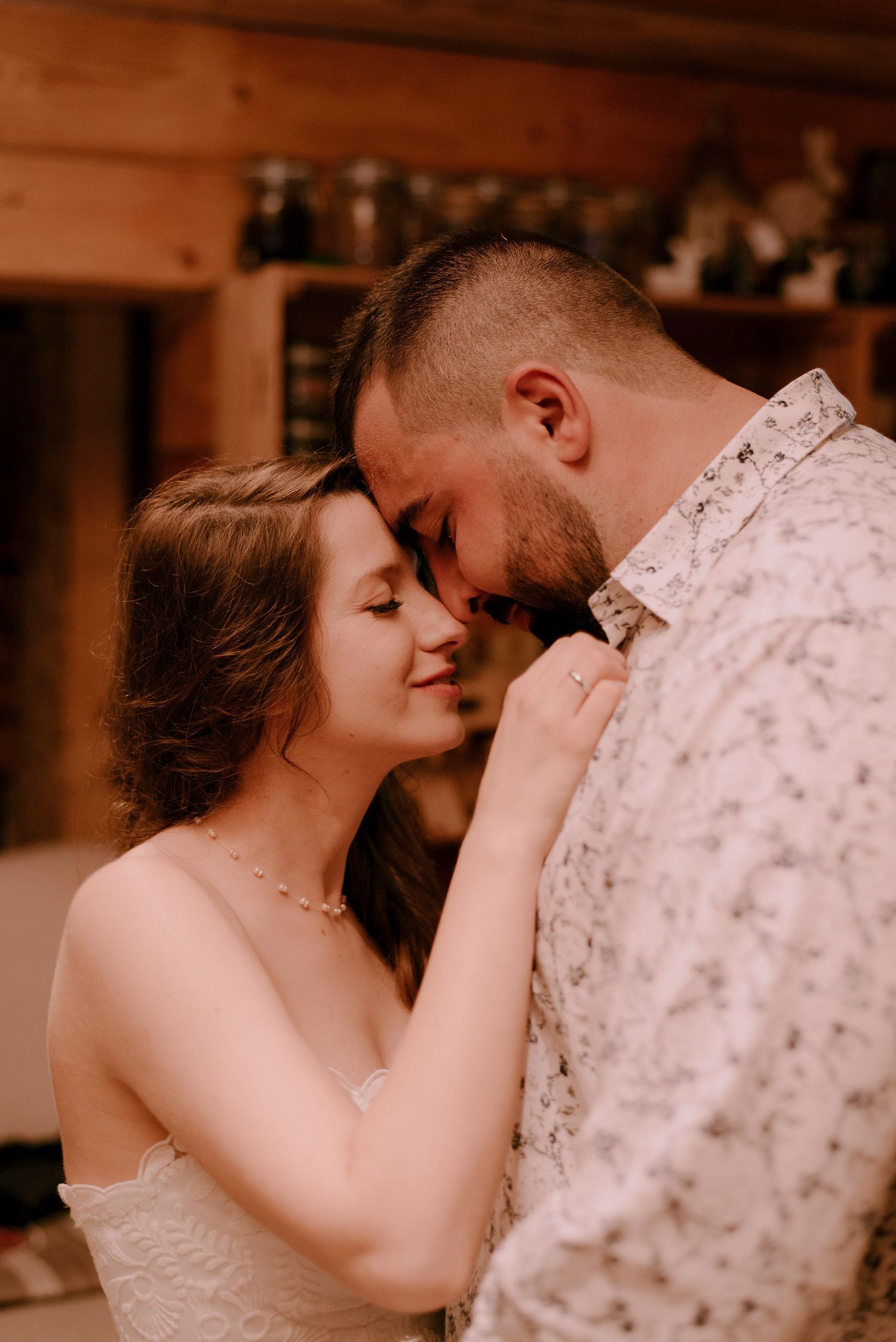 Intimate dance moment captured in warm lighting at indoor reception.