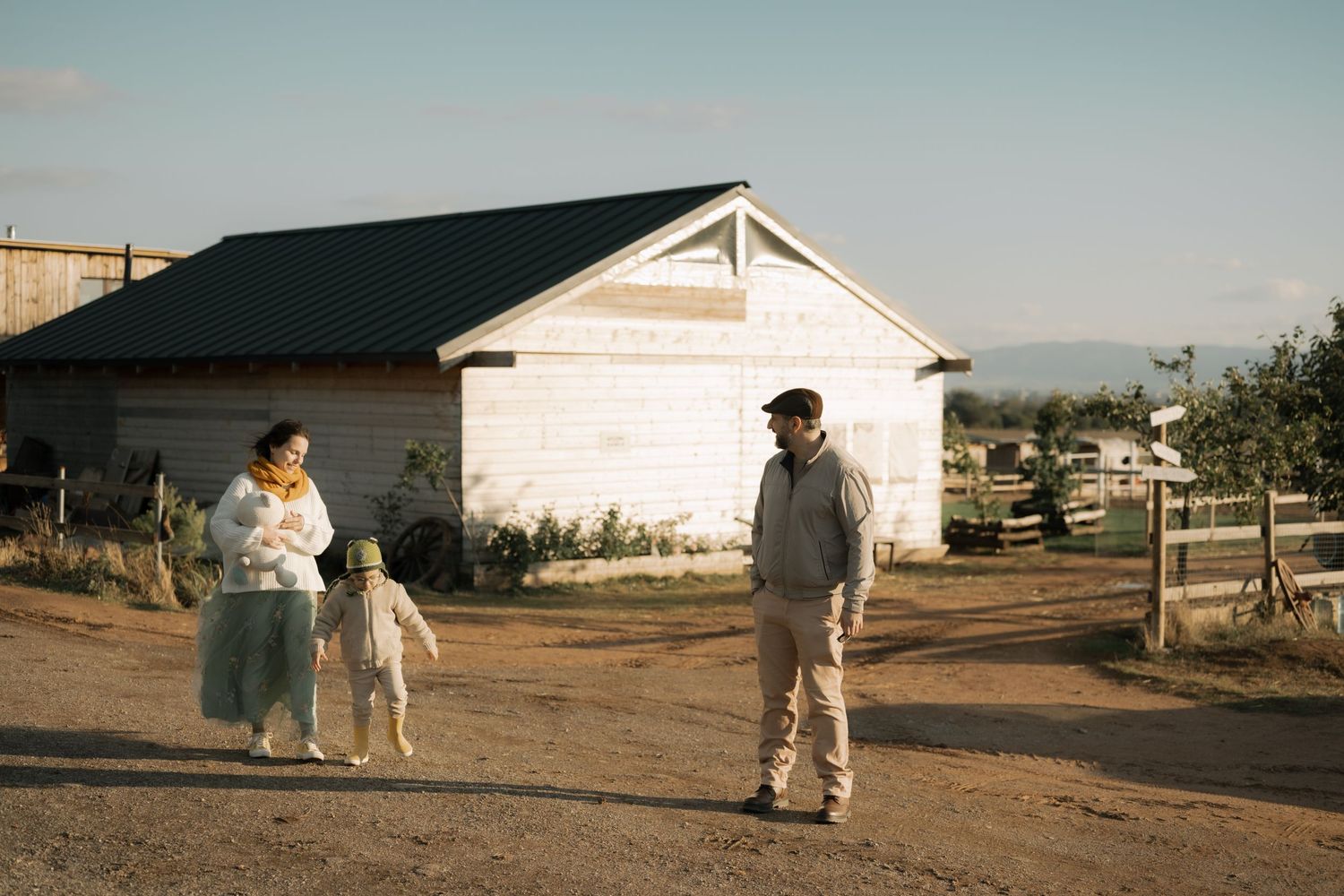 A series of vintage photographs showing people walking near rural houses and buildings in a desert-like setting.