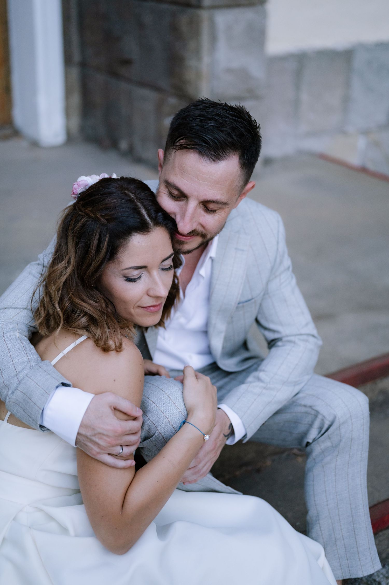 A romantic couple in wedding attire share an intimate embrace in a series of three candid moments.