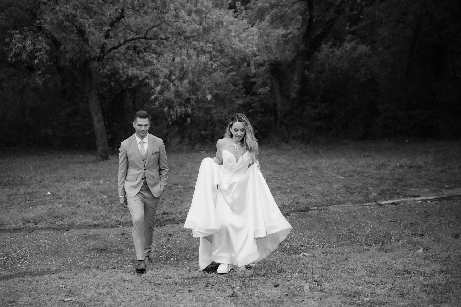 Black and white wedding photos show a couple in romantic poses across a garden setting.