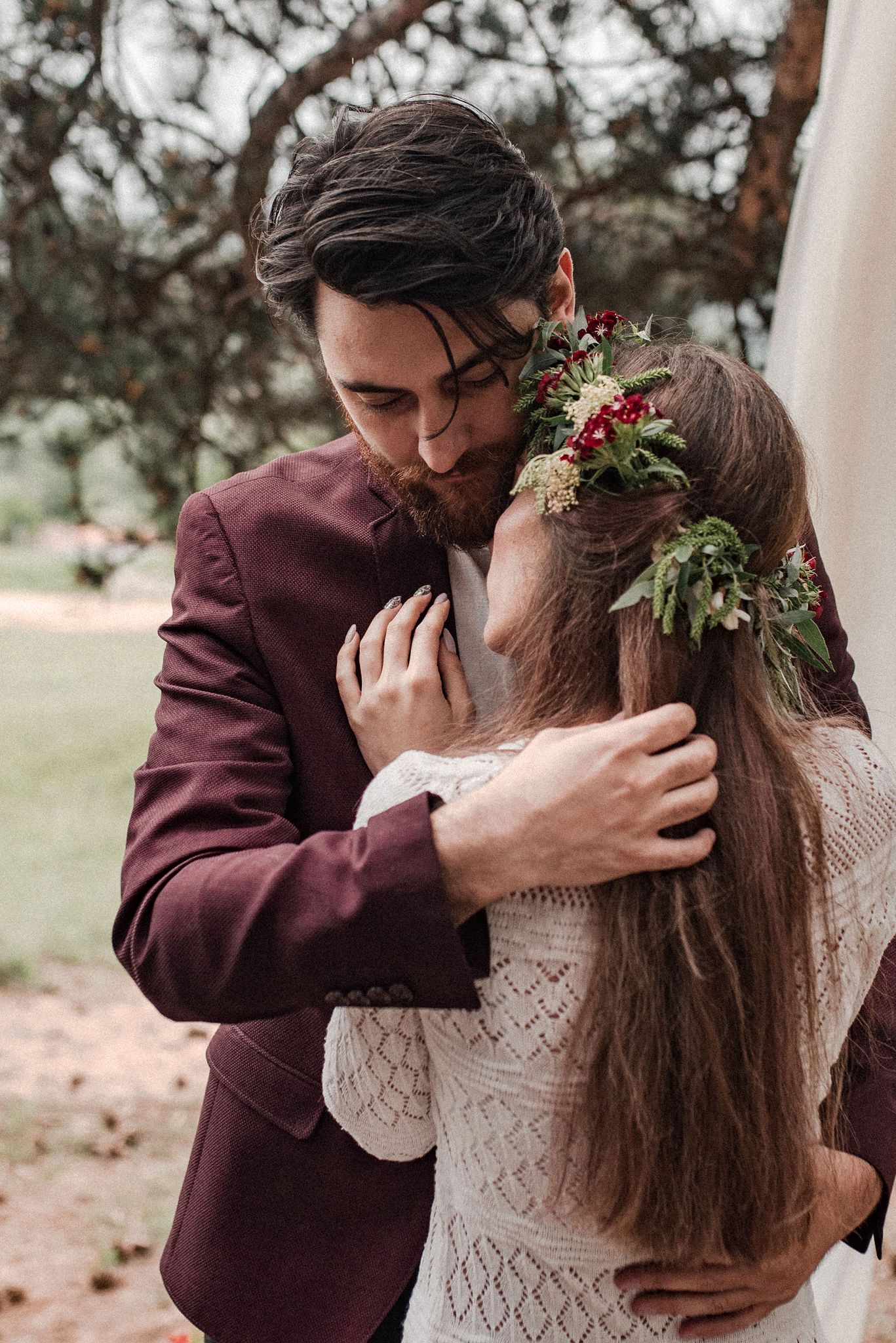 A romantic sequence of wedding photos showing a couple in burgundy and white sharing intimate kisses in an outdoor setting.