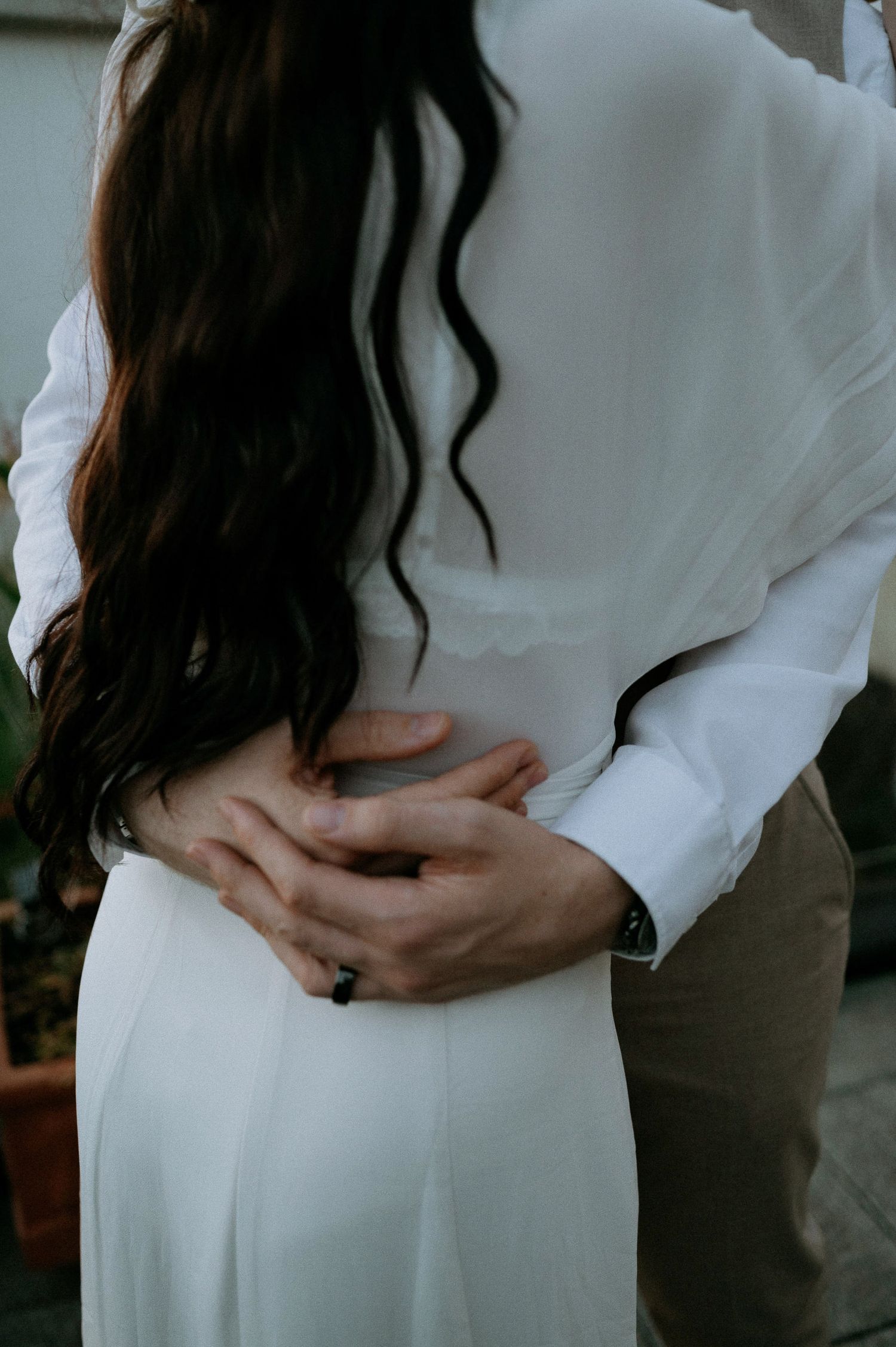 Close-up shots showing gentle embrace in white dress and formal wear.