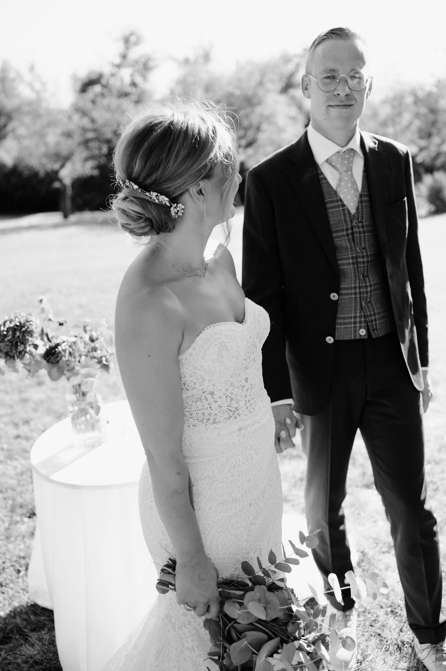 Black and white wedding portraits showing tender moments between couple in garden setting.