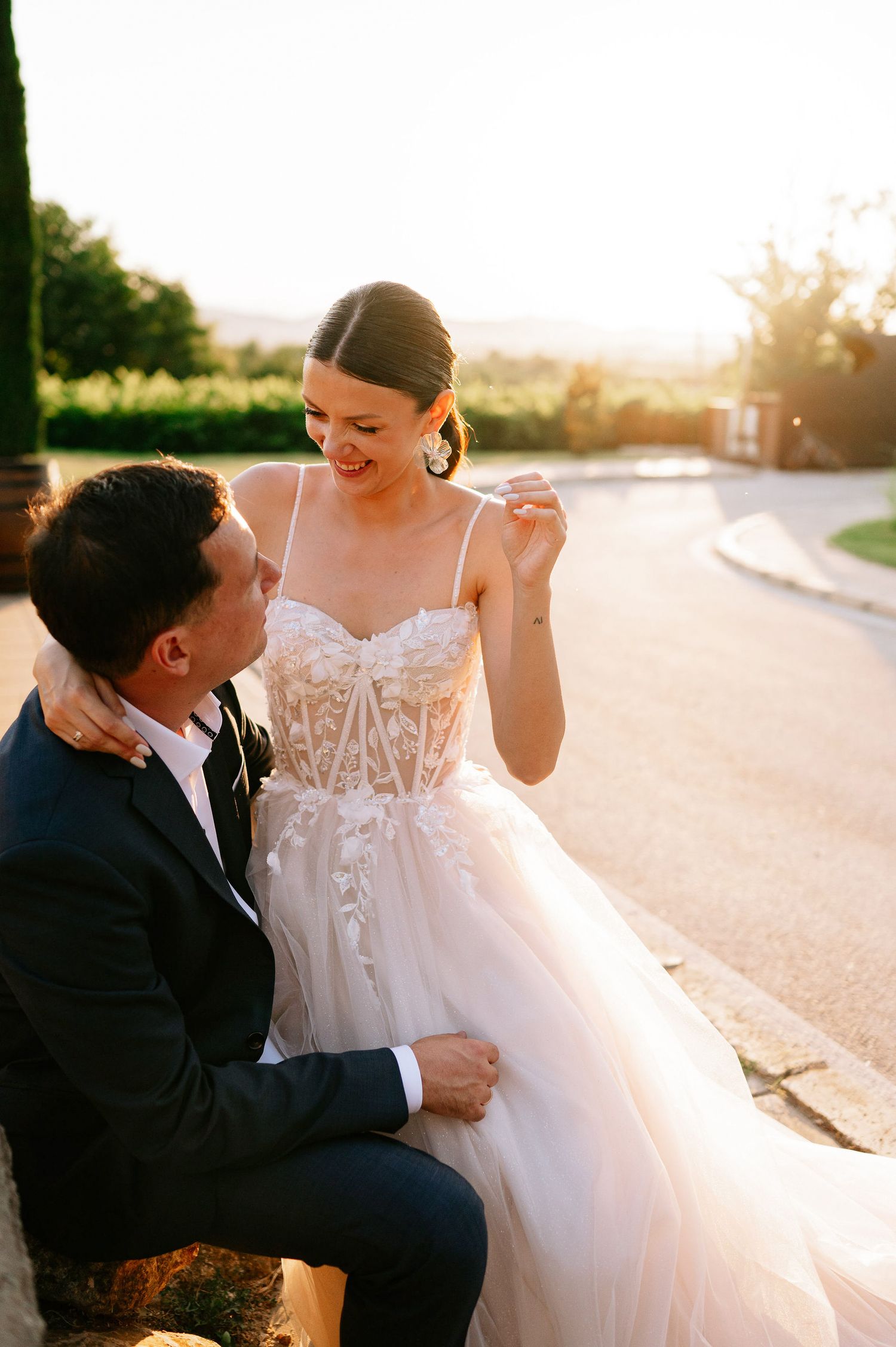 Intimate wedding couple sharing a tender moment in warm sunset light.