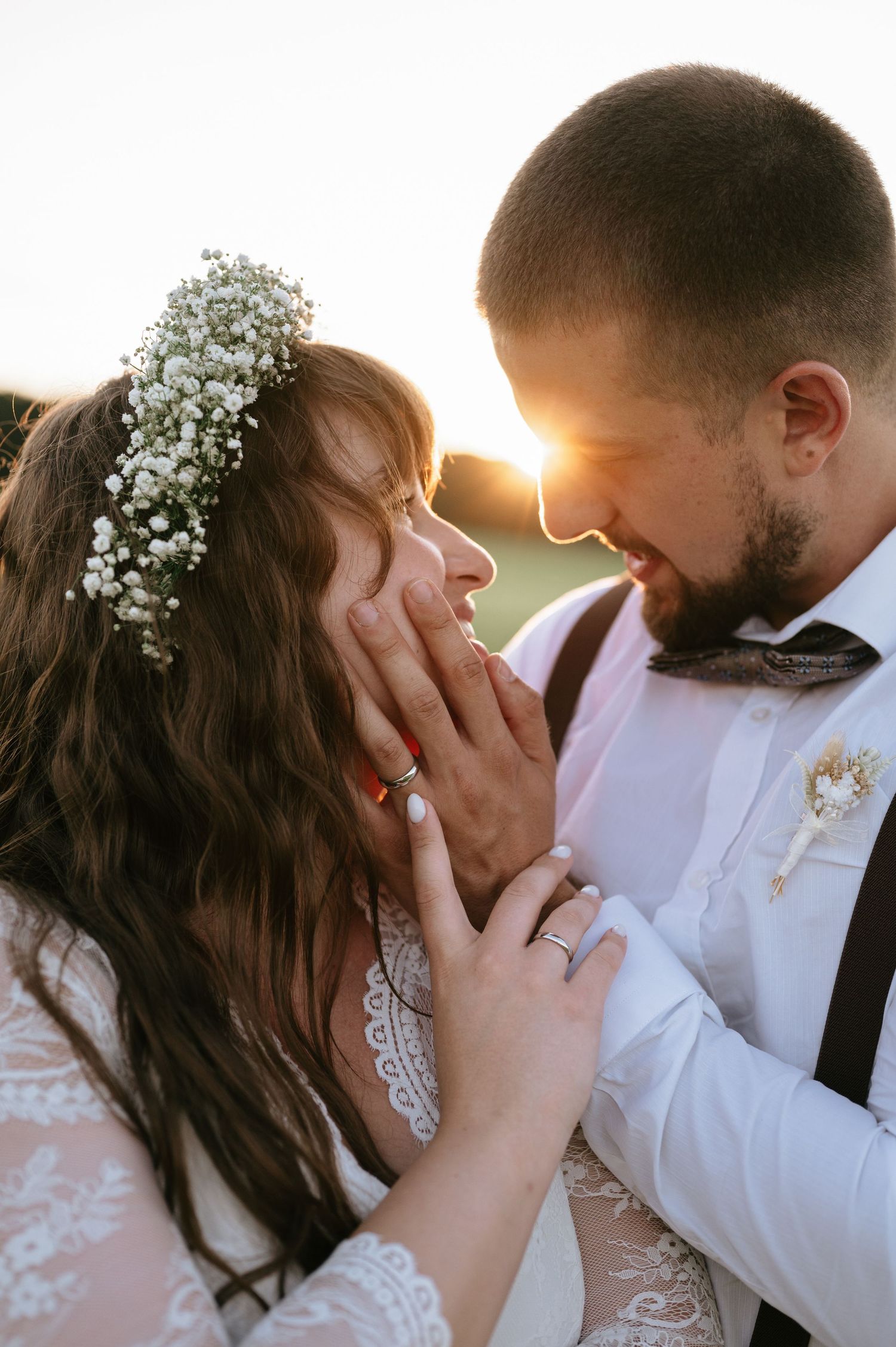 Intimate wedding portrait with soft lighting and baby's breath flowers.