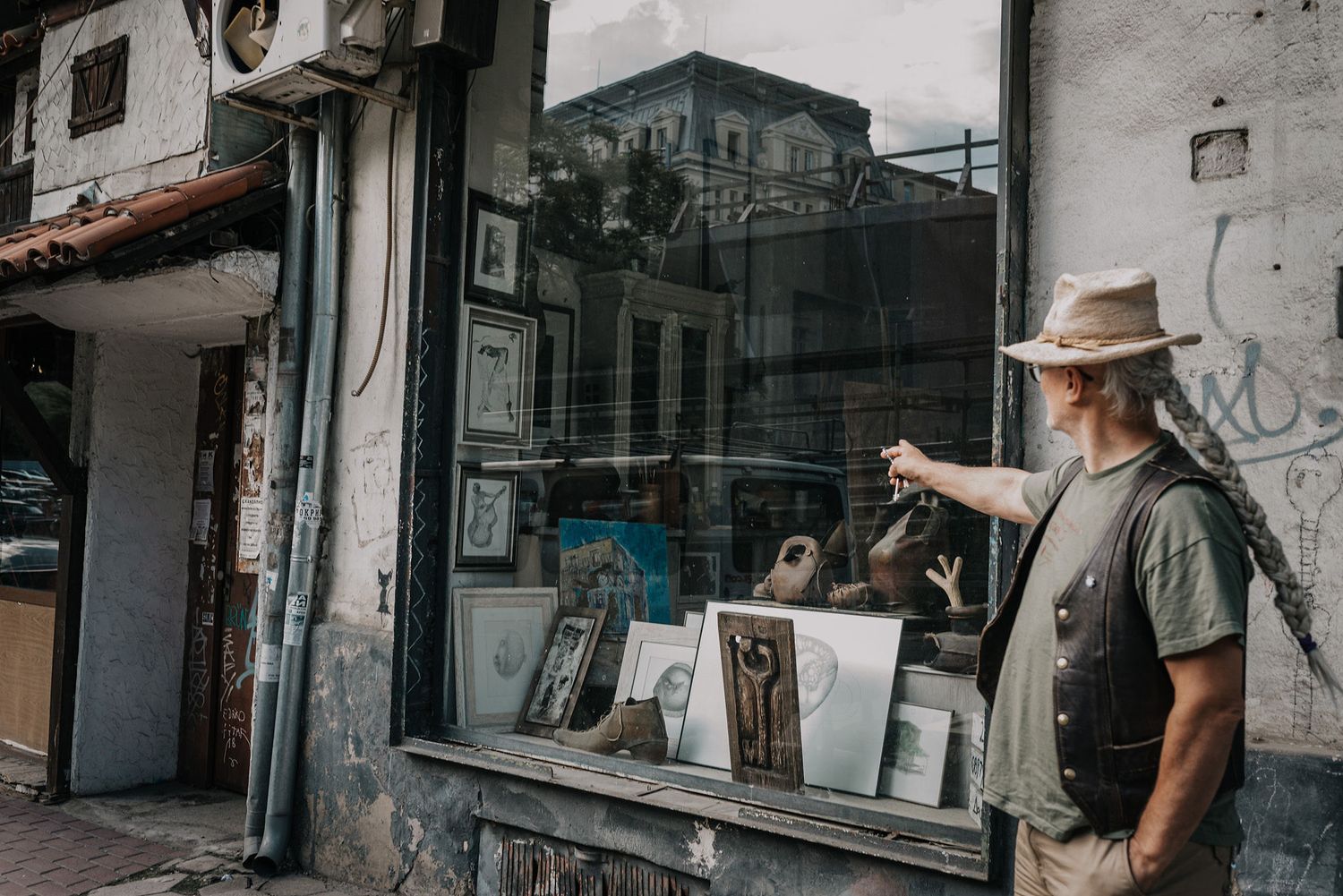 View of a vintage storefront with weathered architecture and window displays.