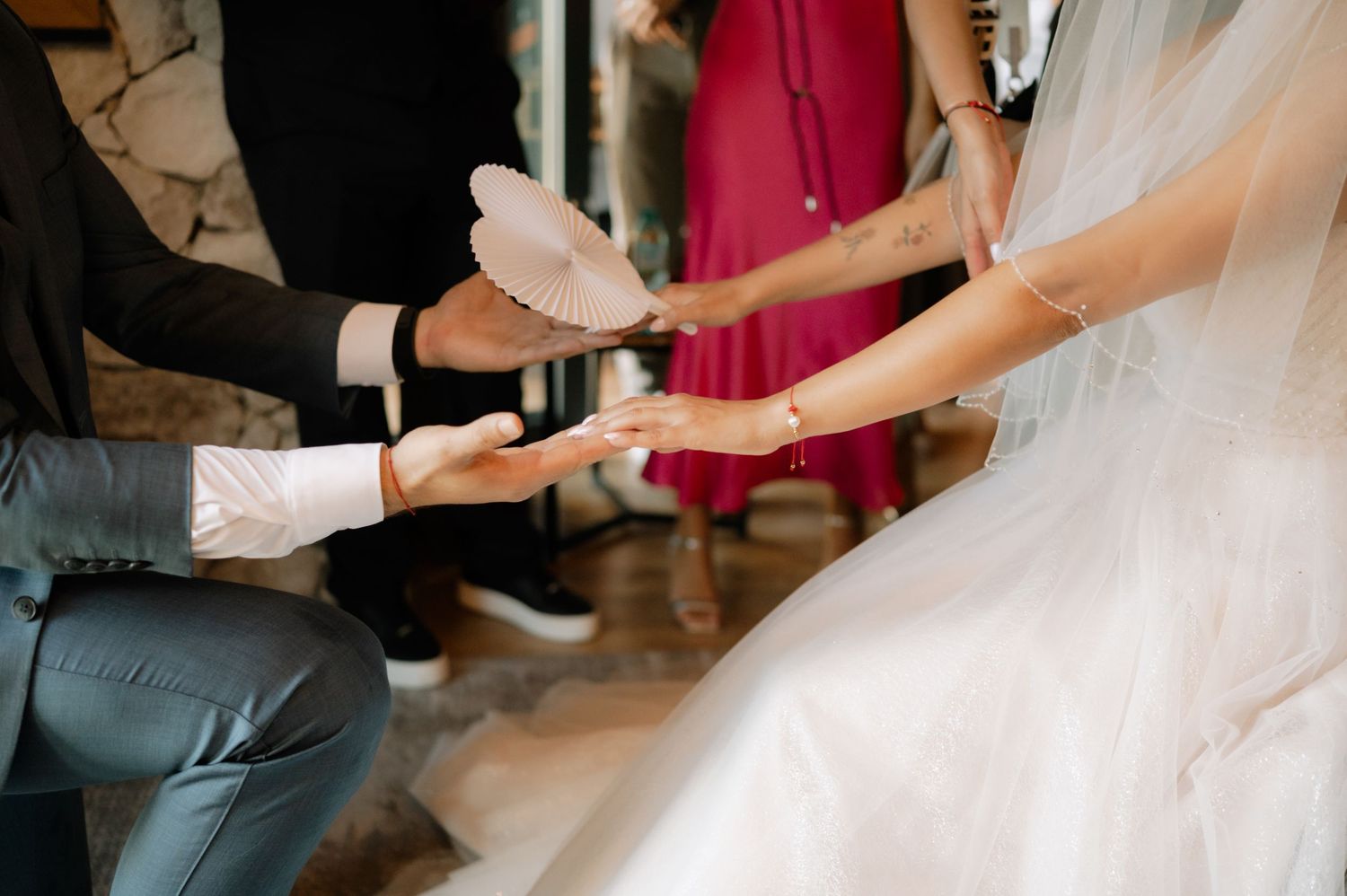 Close-up of someone trying on white ballet shoes or pointe shoes during a fitting session.