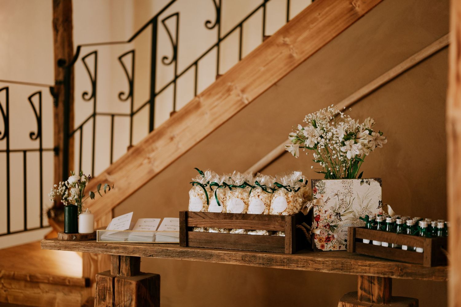 Wooden staircase with wrought iron railings and decorative elements in warm lighting.