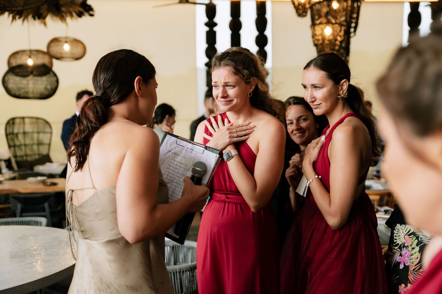 Wedding celebration with attendees in formal attire sharing a joyful moment.