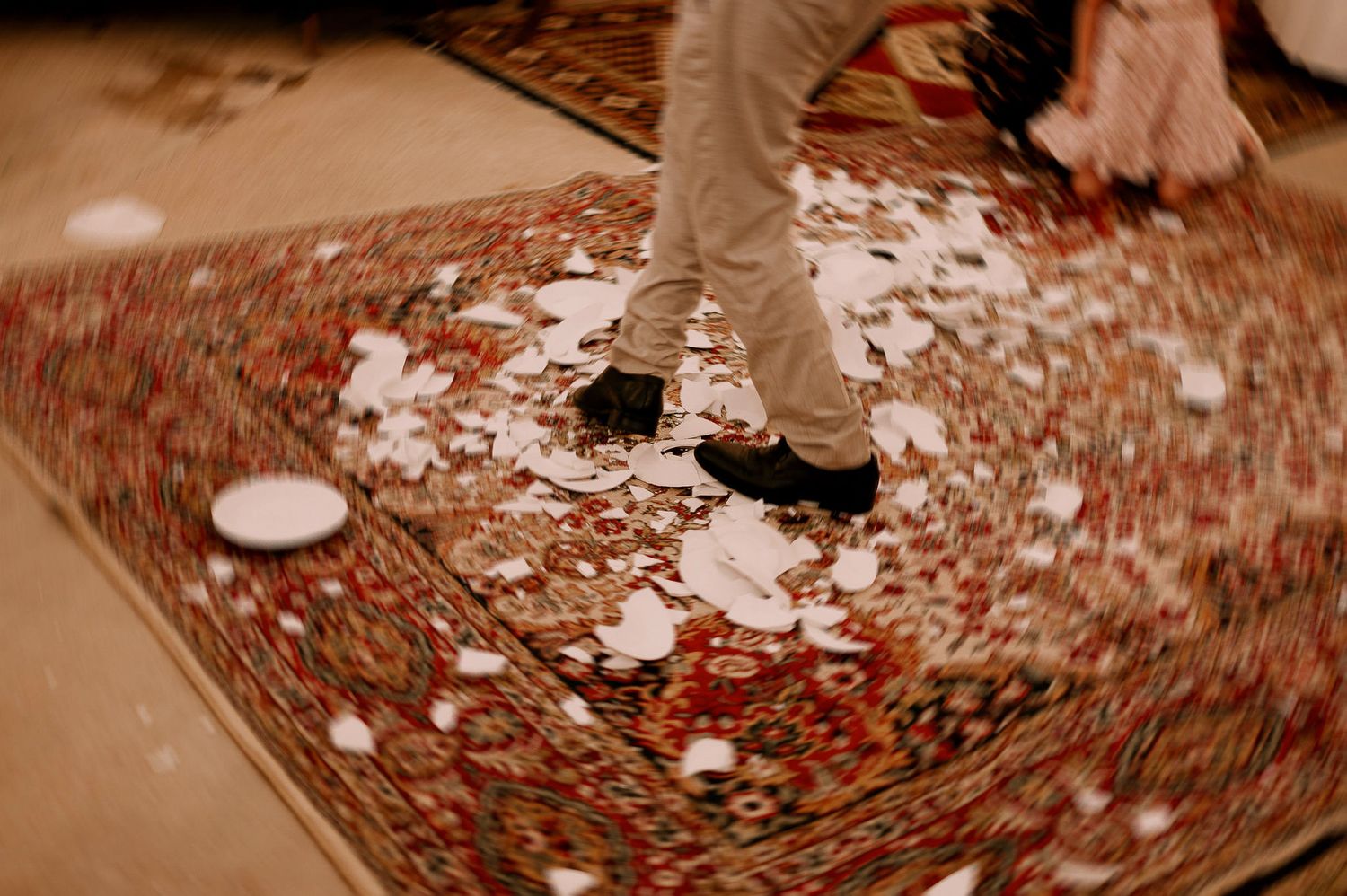 Close-up of confetti scattered on an ornate carpet during wedding reception.