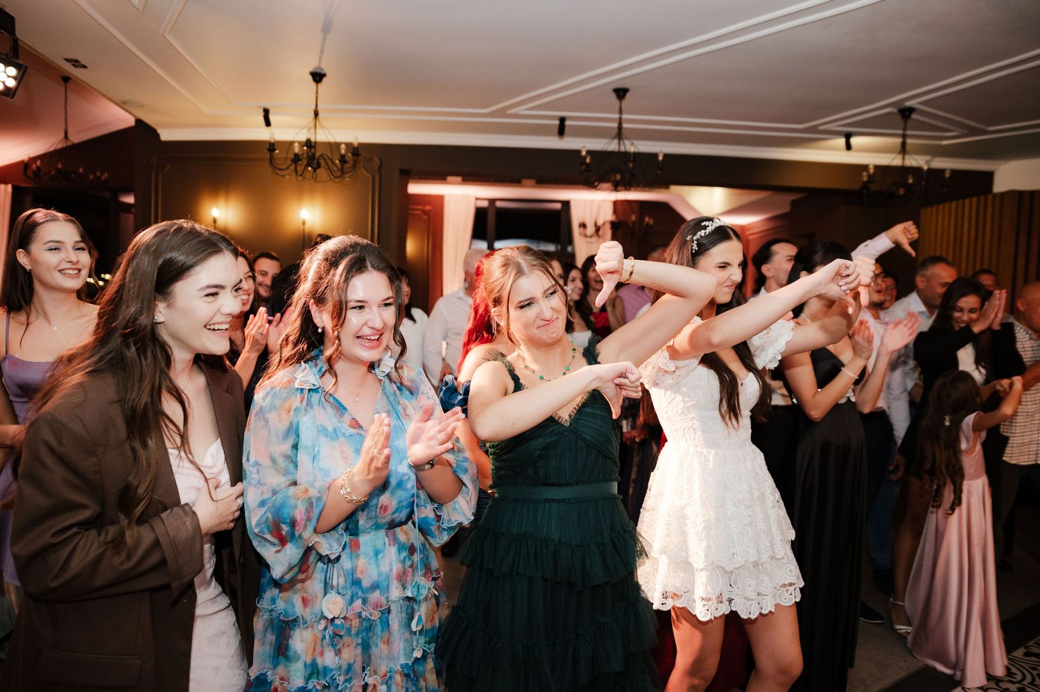 Wedding reception dance floor filled with guests dancing and celebrating.