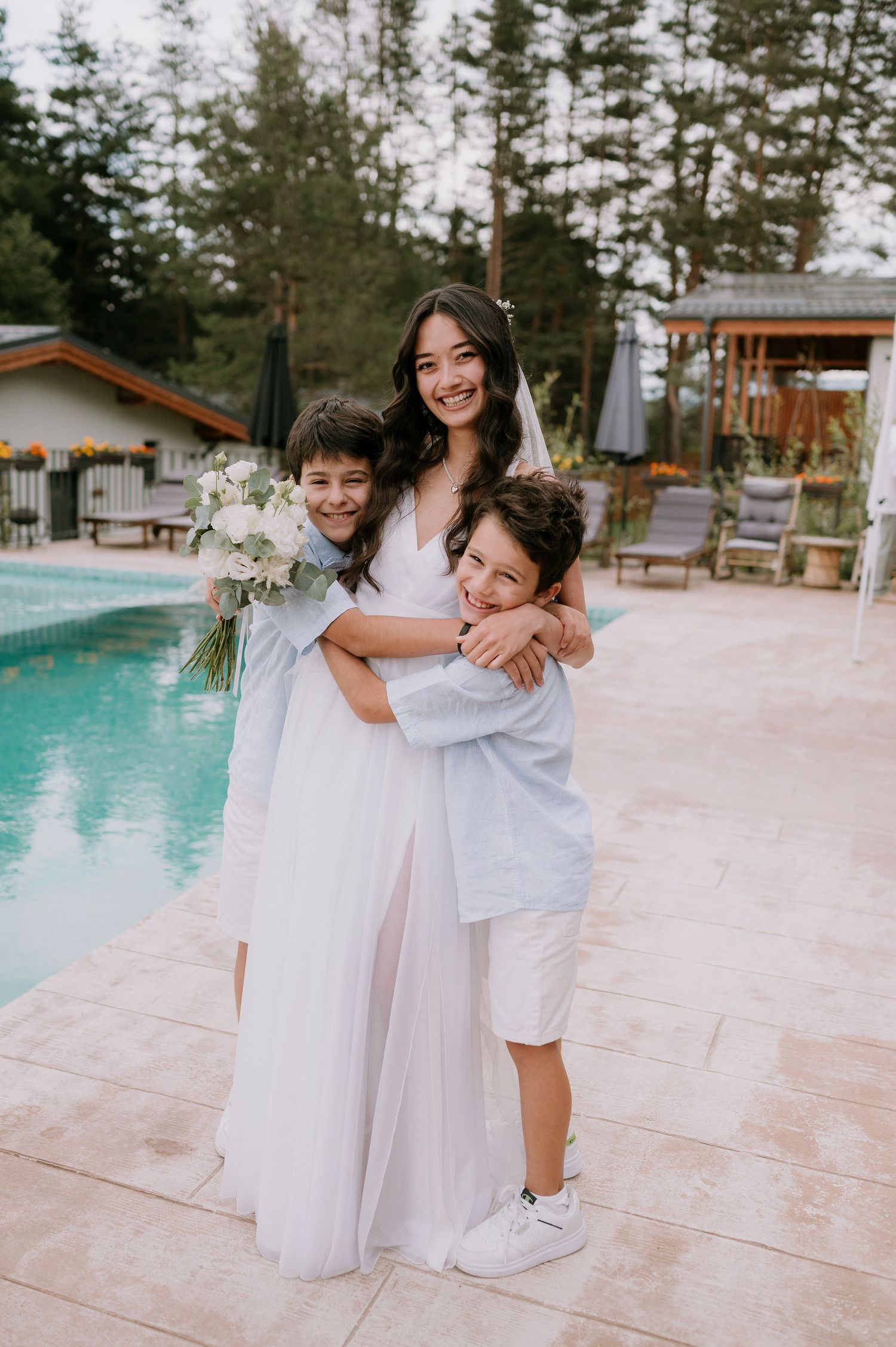 Candid celebration moments by the pool during a wedding reception.