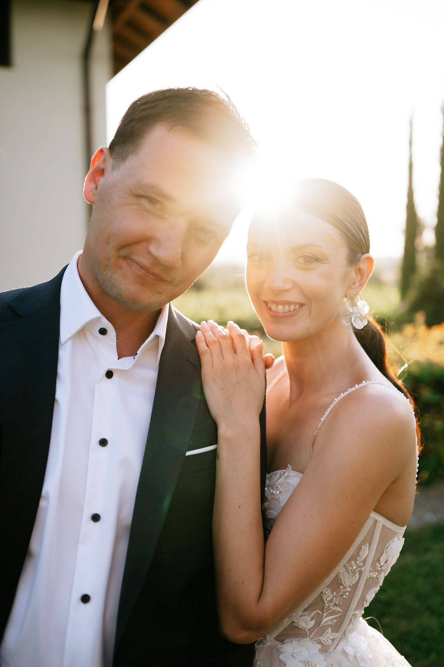 Newlyweds share intimate laughs during sunset wedding photoshoot.