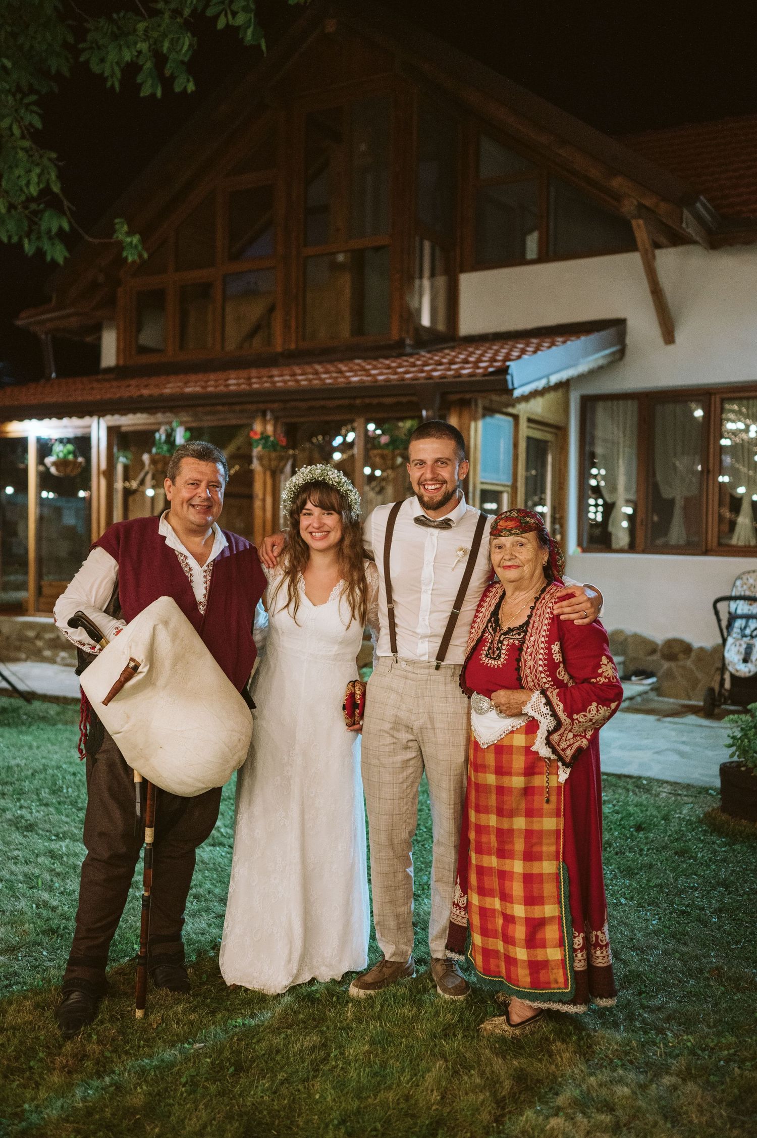 Wedding group portrait combining traditional folk costumes with modern wedding attire.