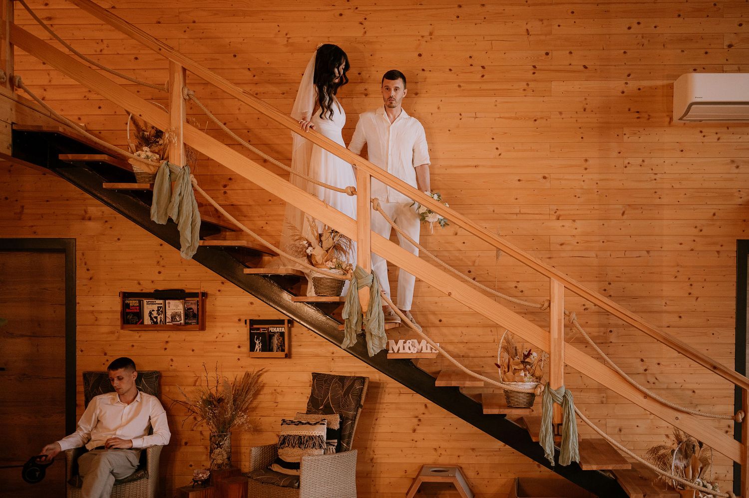 A sequence of wedding photos on wooden stairs in a rustic interior setting.