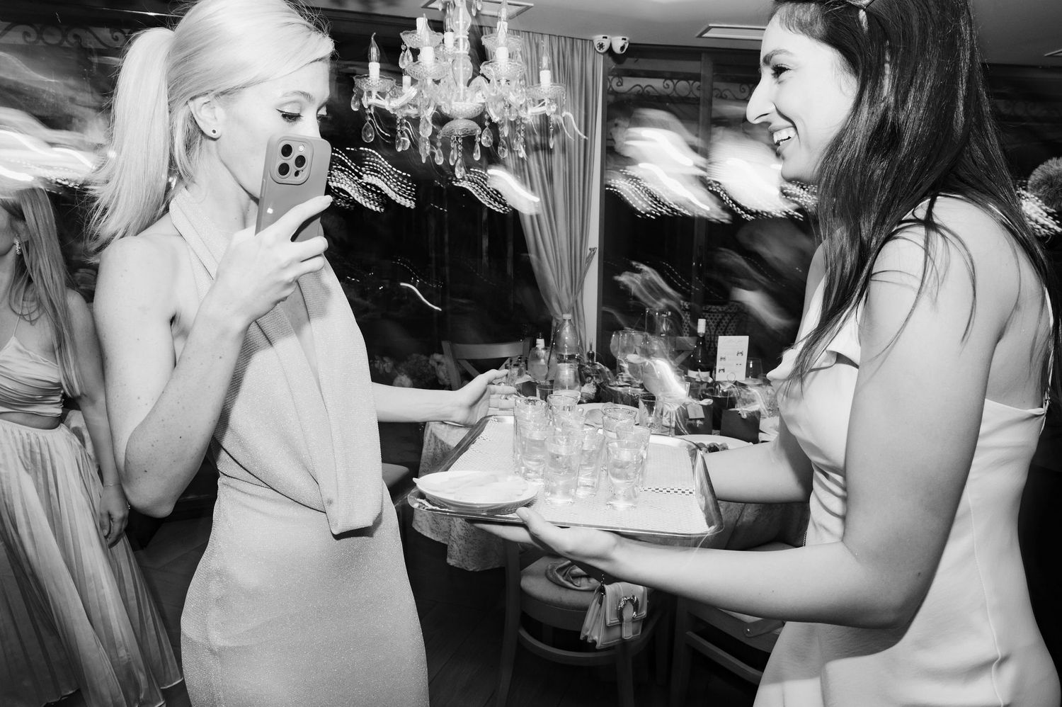 A series of black and white photographs showing people preparing food and drinks in a restaurant or bar setting.
