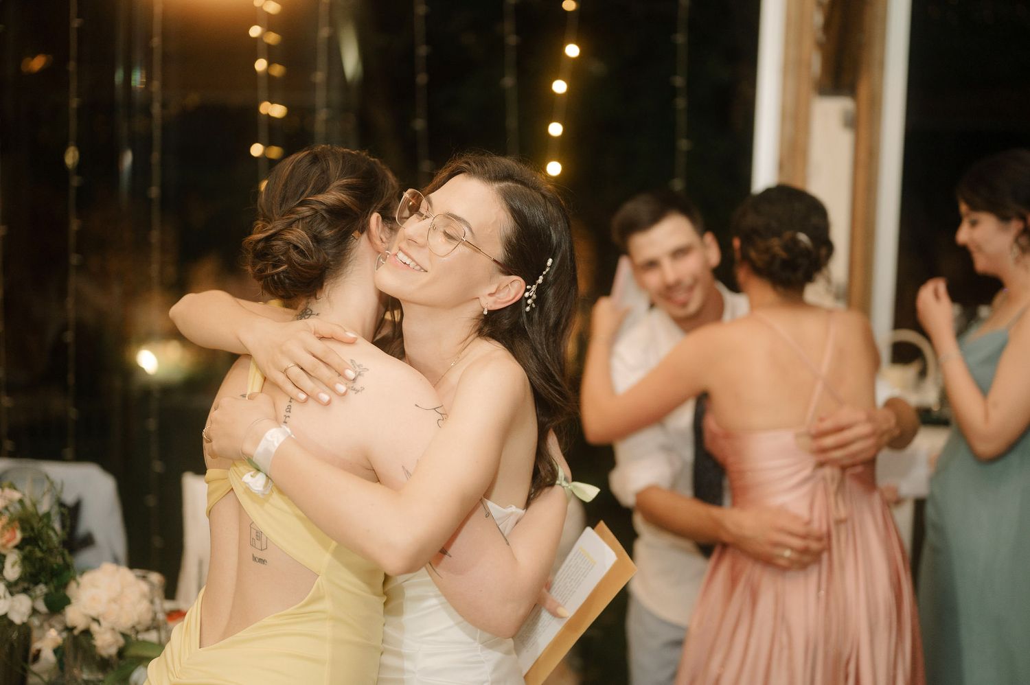 A series of wedding photos showing couples and wedding party members embracing in an emotional celebration.