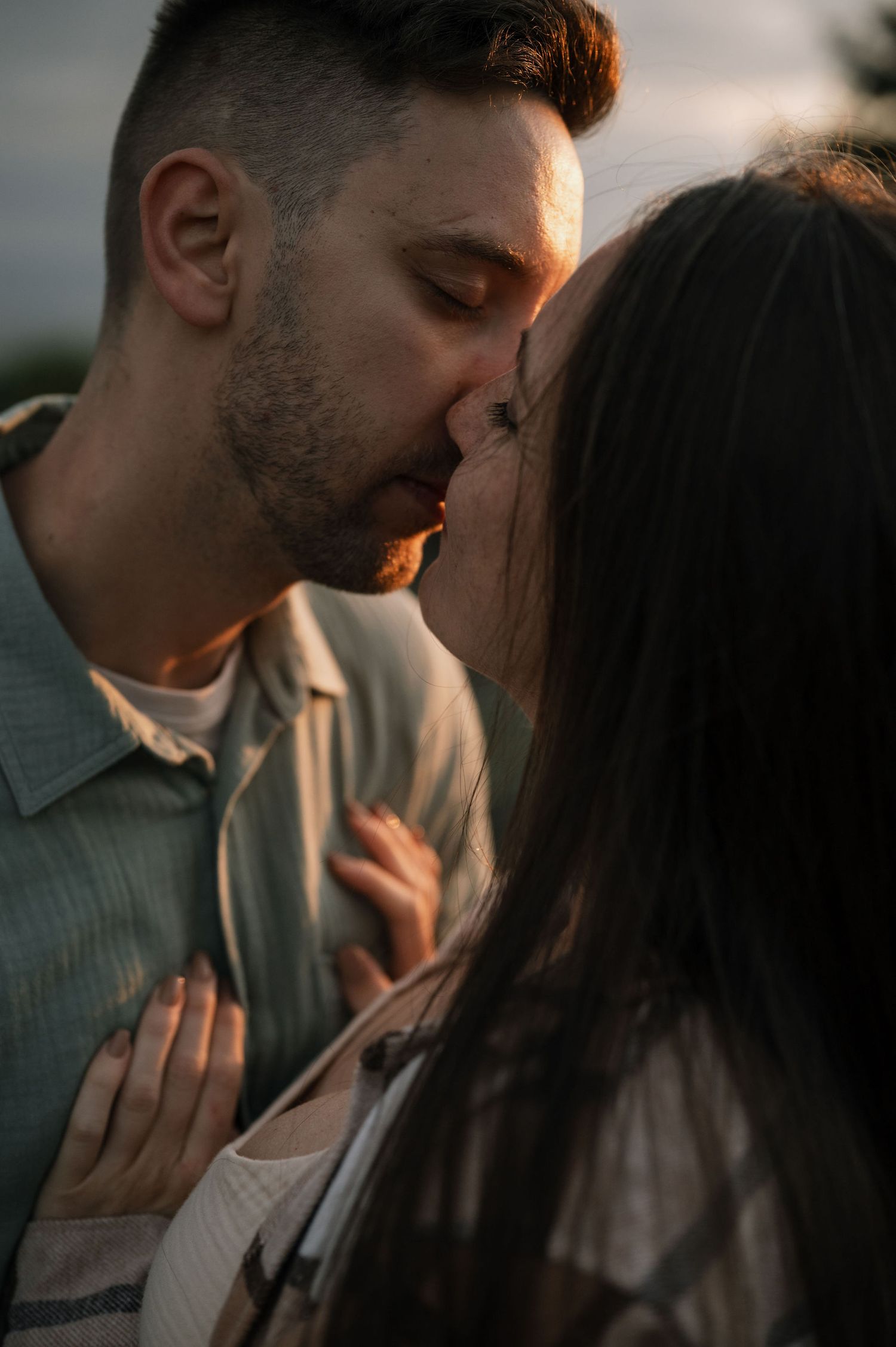 Romantic couple sharing intimate moments in a series of close-up shots during golden hour lighting.