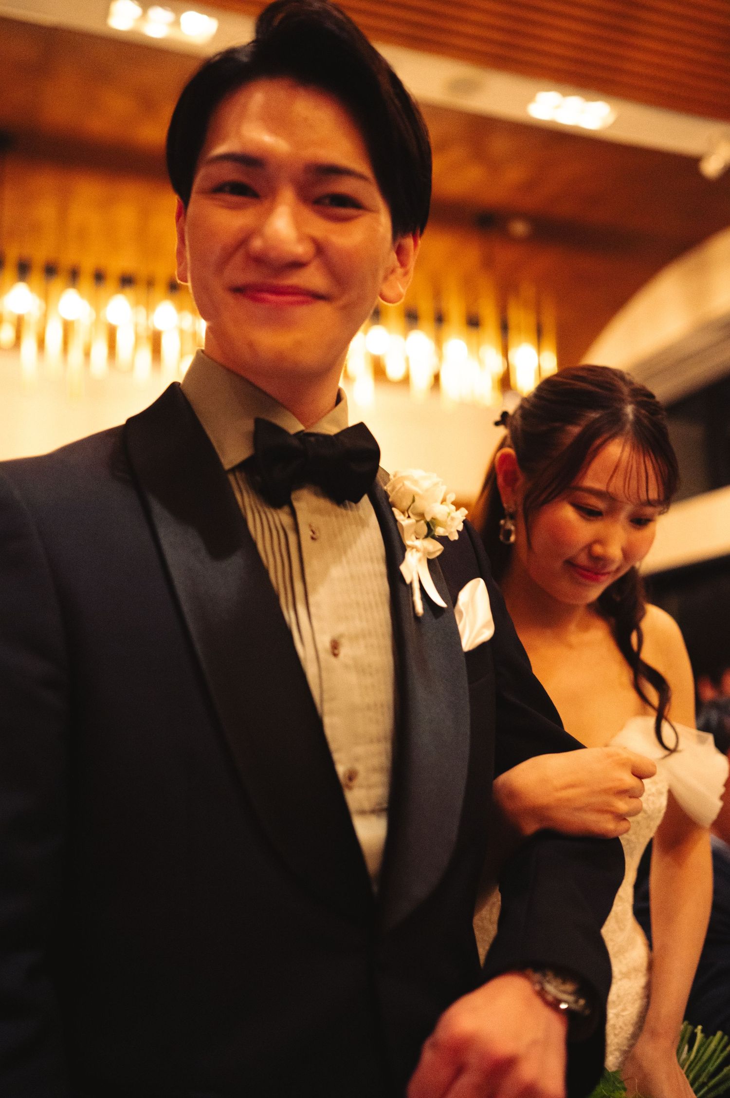 Wedding couple shares intimate moments during their reception under warm lighting.