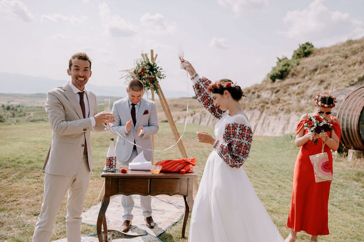 Wedding party gathered for an outdoor ceremony with desert mountain backdrop.