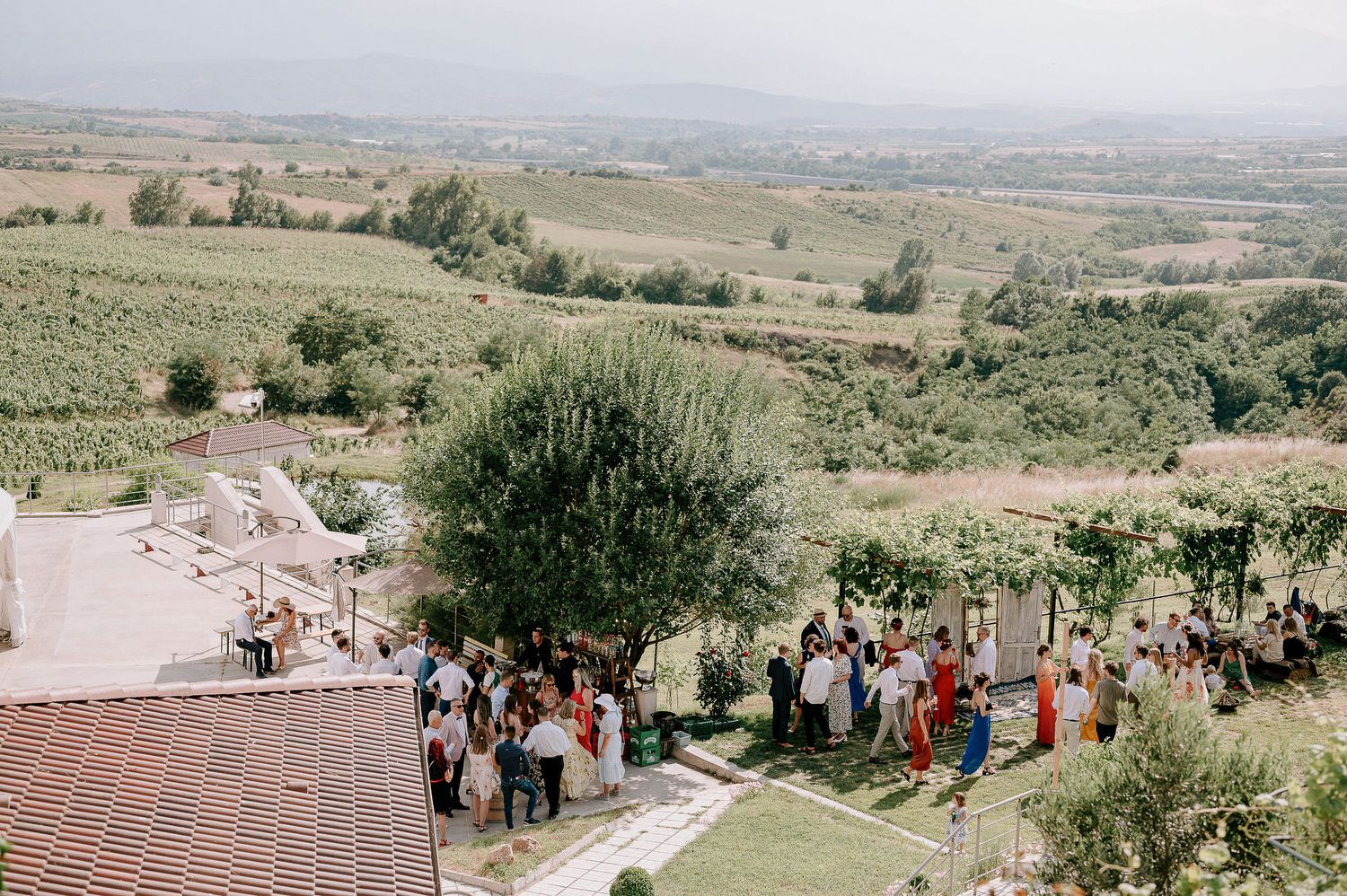 Scenic outdoor wedding venue overlooking rolling hills and distant mountains.