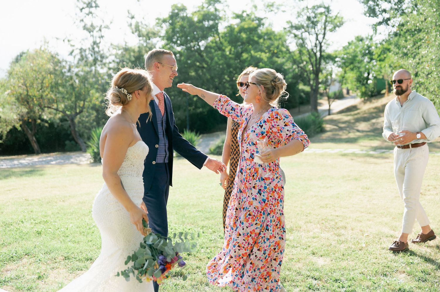 Wedding celebration captured in a series of candid moments on a beautiful summer day.